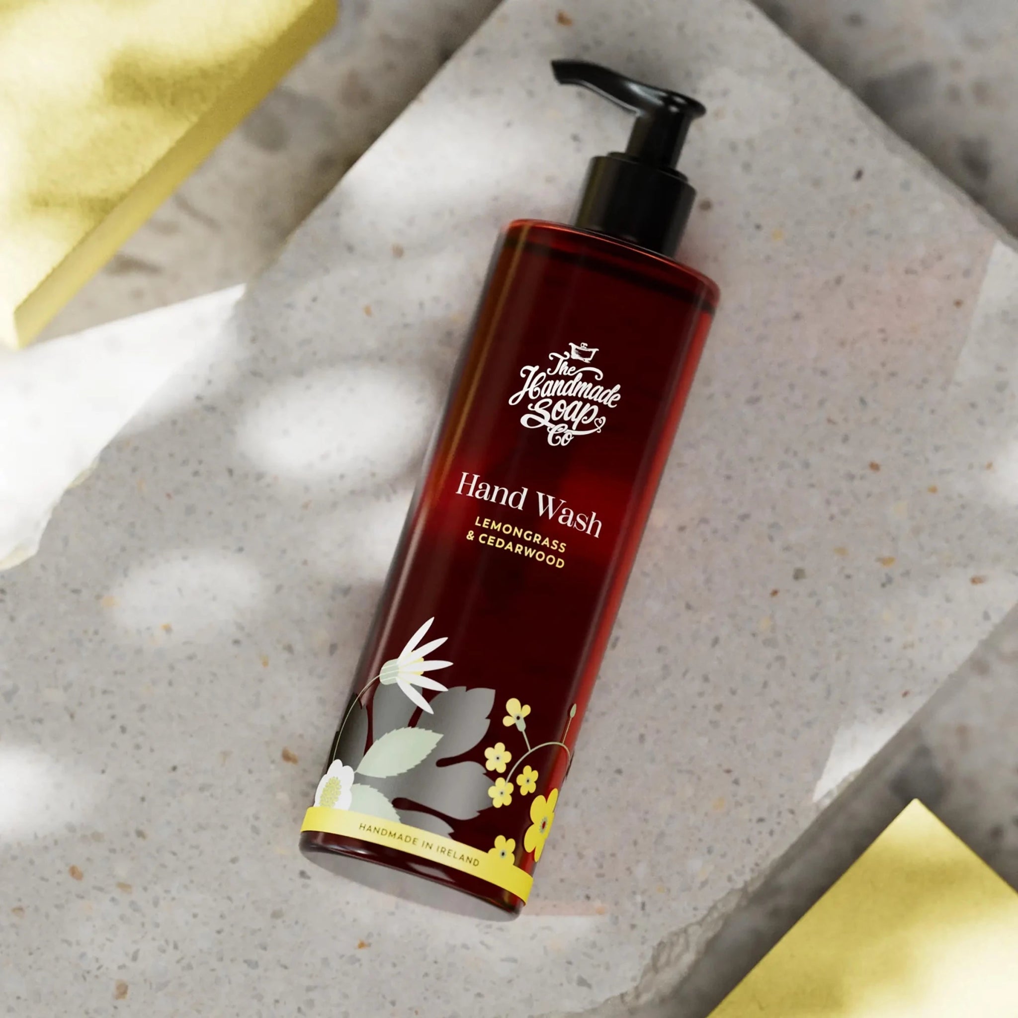 Handmade soap hand wash bottle with pump on a stone surface