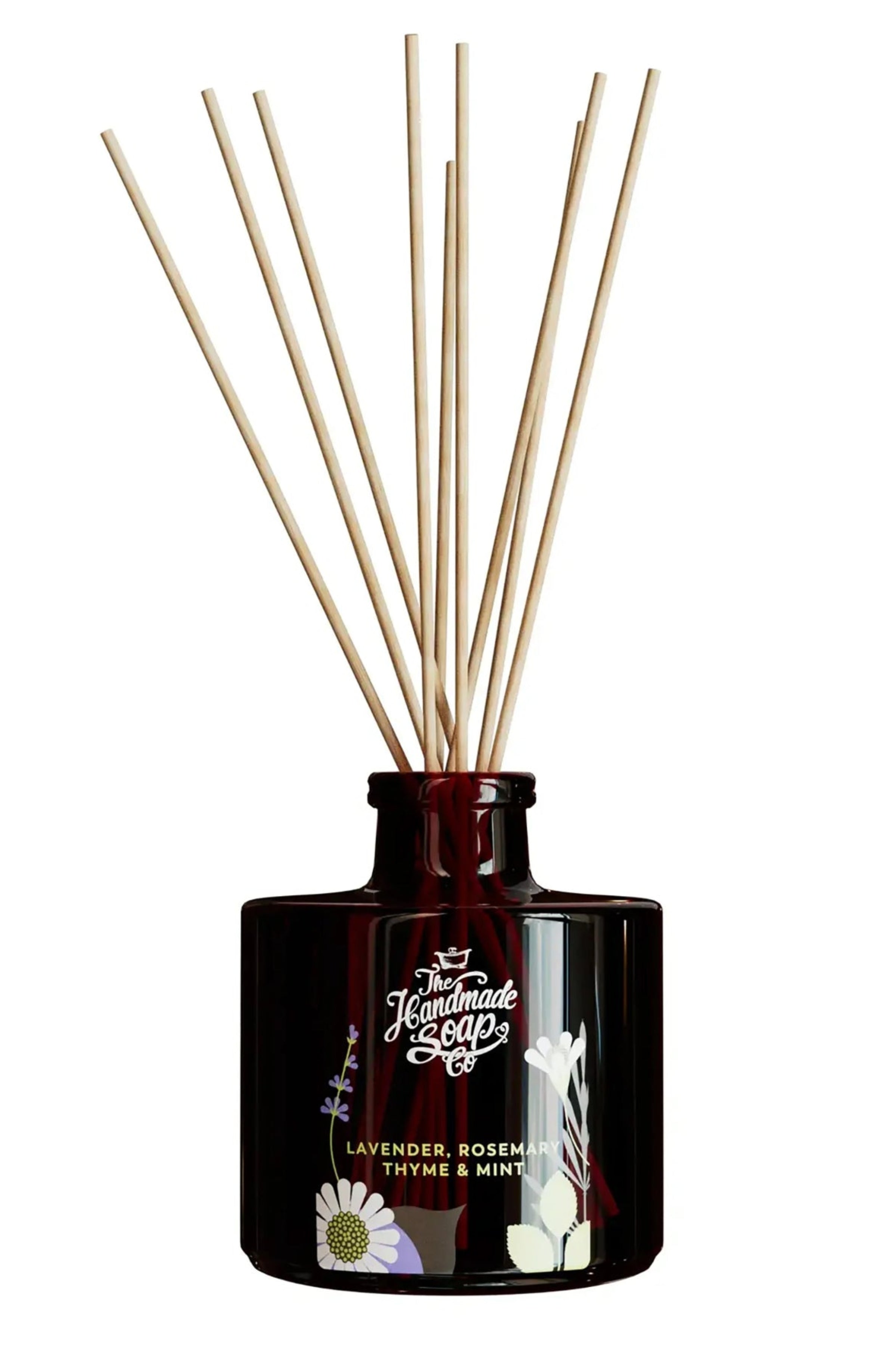 Reed diffuser with wooden sticks in a brown bottle on a white background