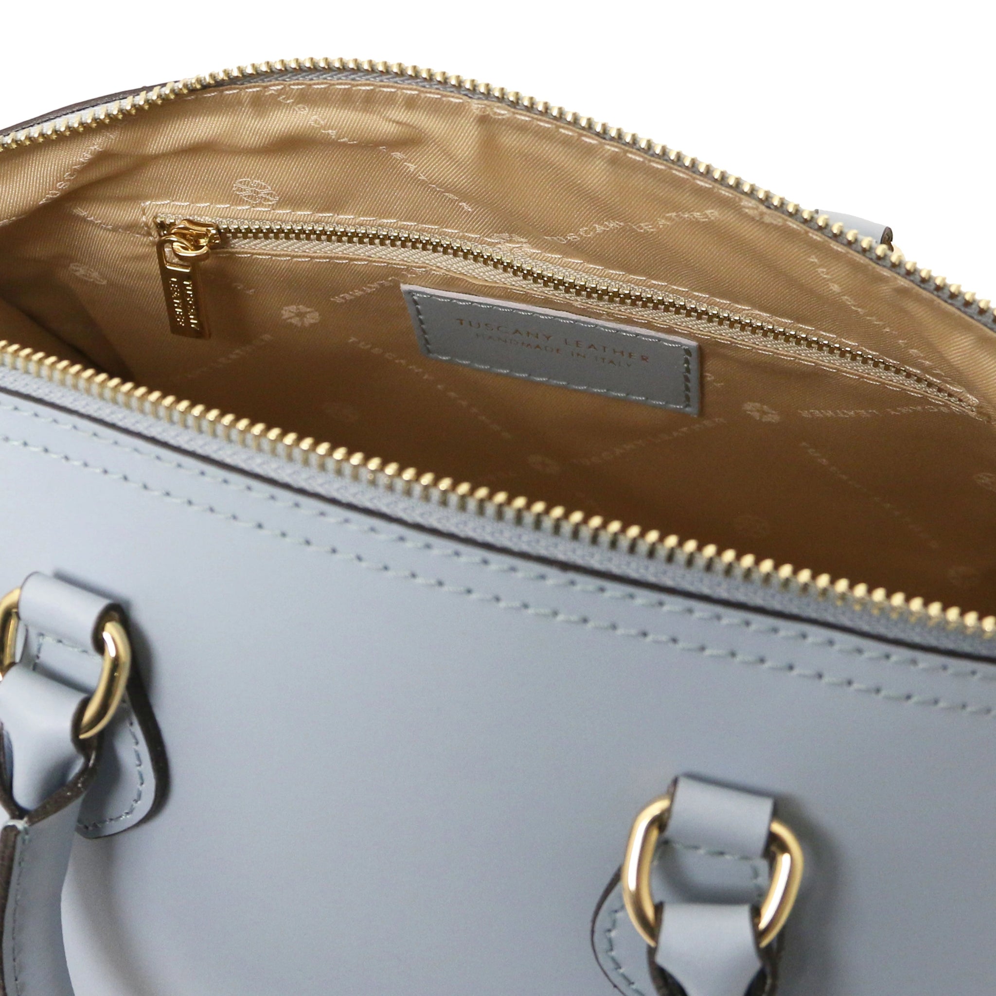 Interior zip pocket view of Layla Italian Leather Duffle Bag in light blue showing beige bag lining