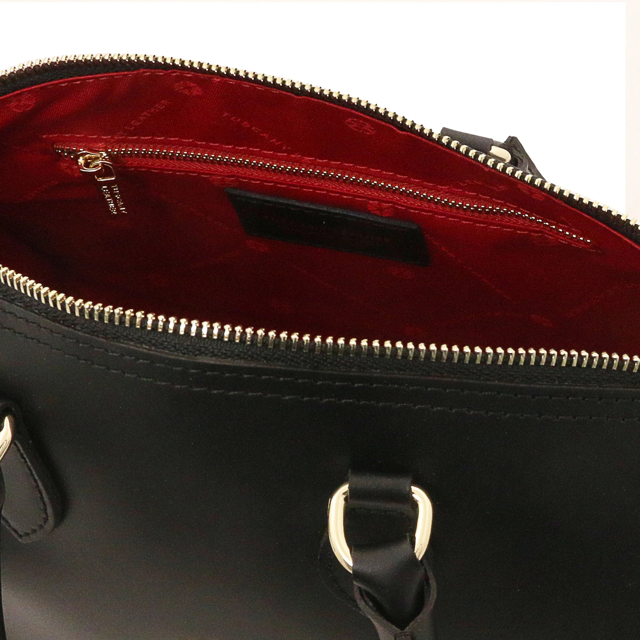 Interior zip pocket view of Layla Italian Leather Duffle Bag in black showing the vibrant red lining