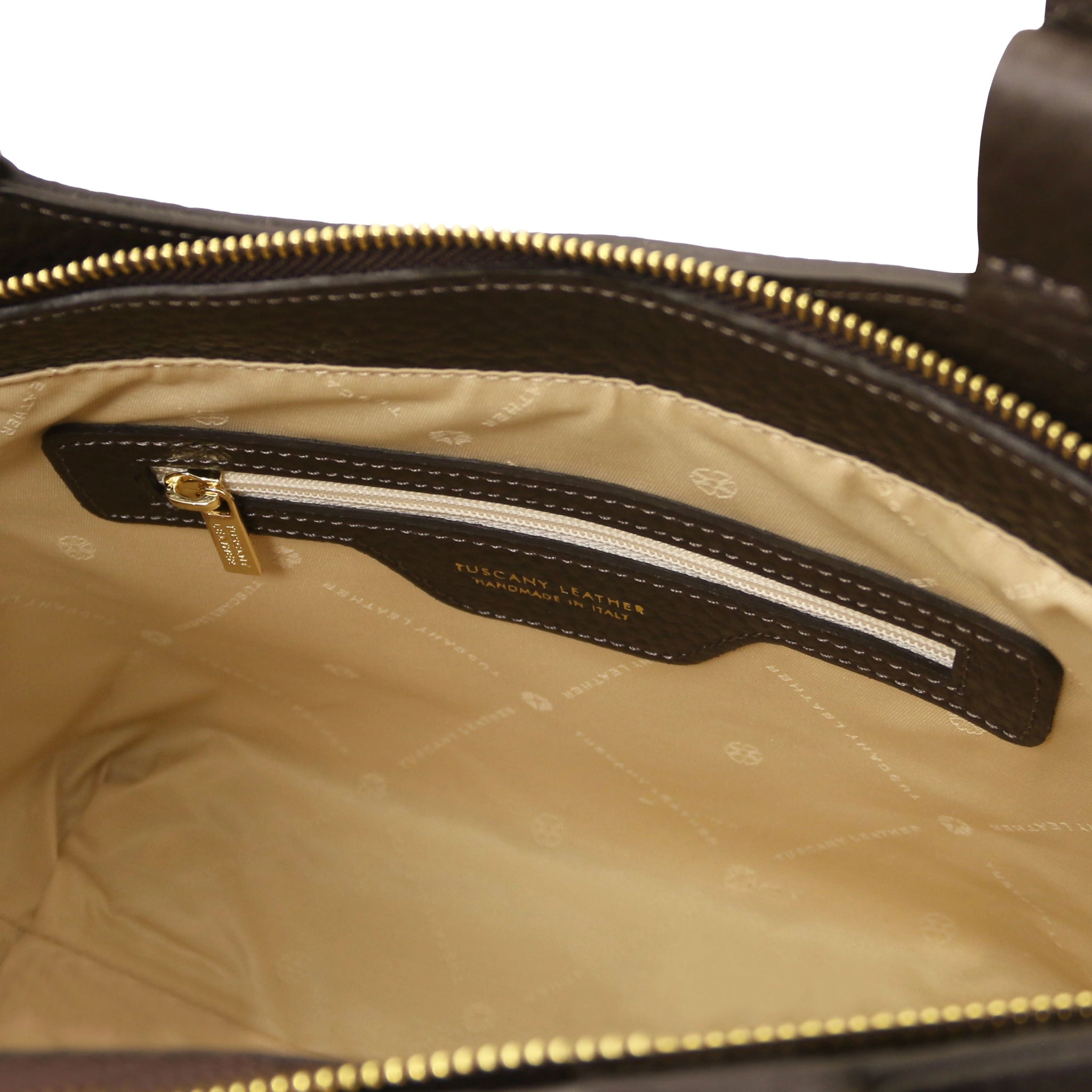 Interior zip pocket of the Libra Leather Suede Shoulder Bag in dark brown with beige lining and gold zipp