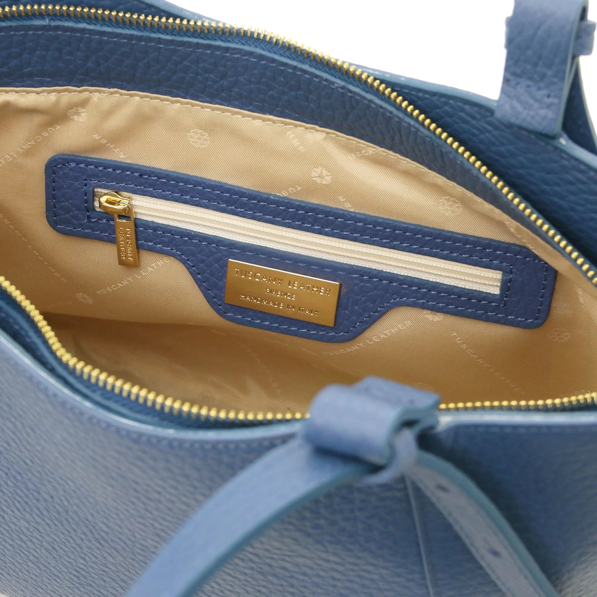 Interior zip pocket view Libra Leather Shoulder Bag in denim with tan lining