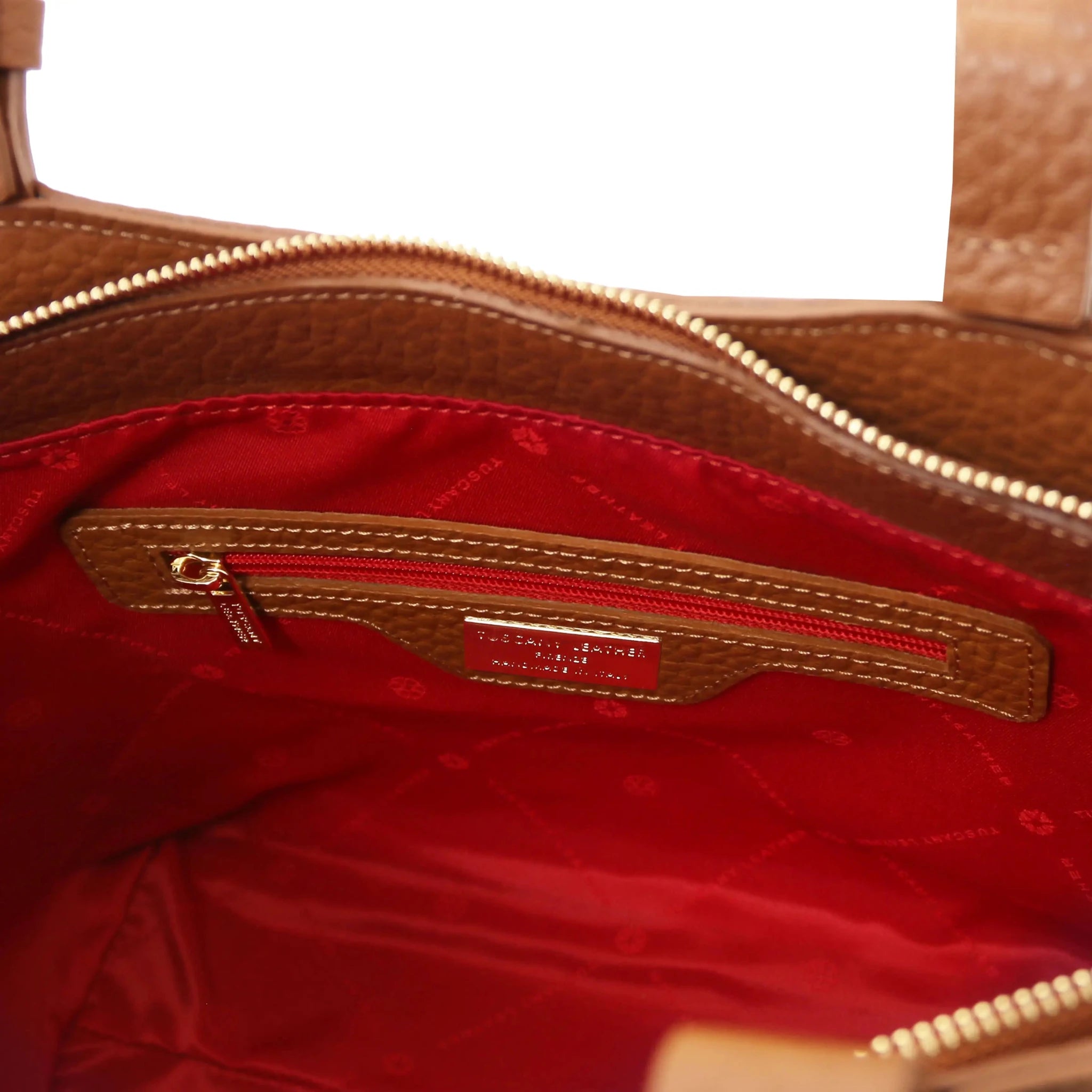 Interior zip pocket view Libra Leather Shoulder Bag in cognac with red lining