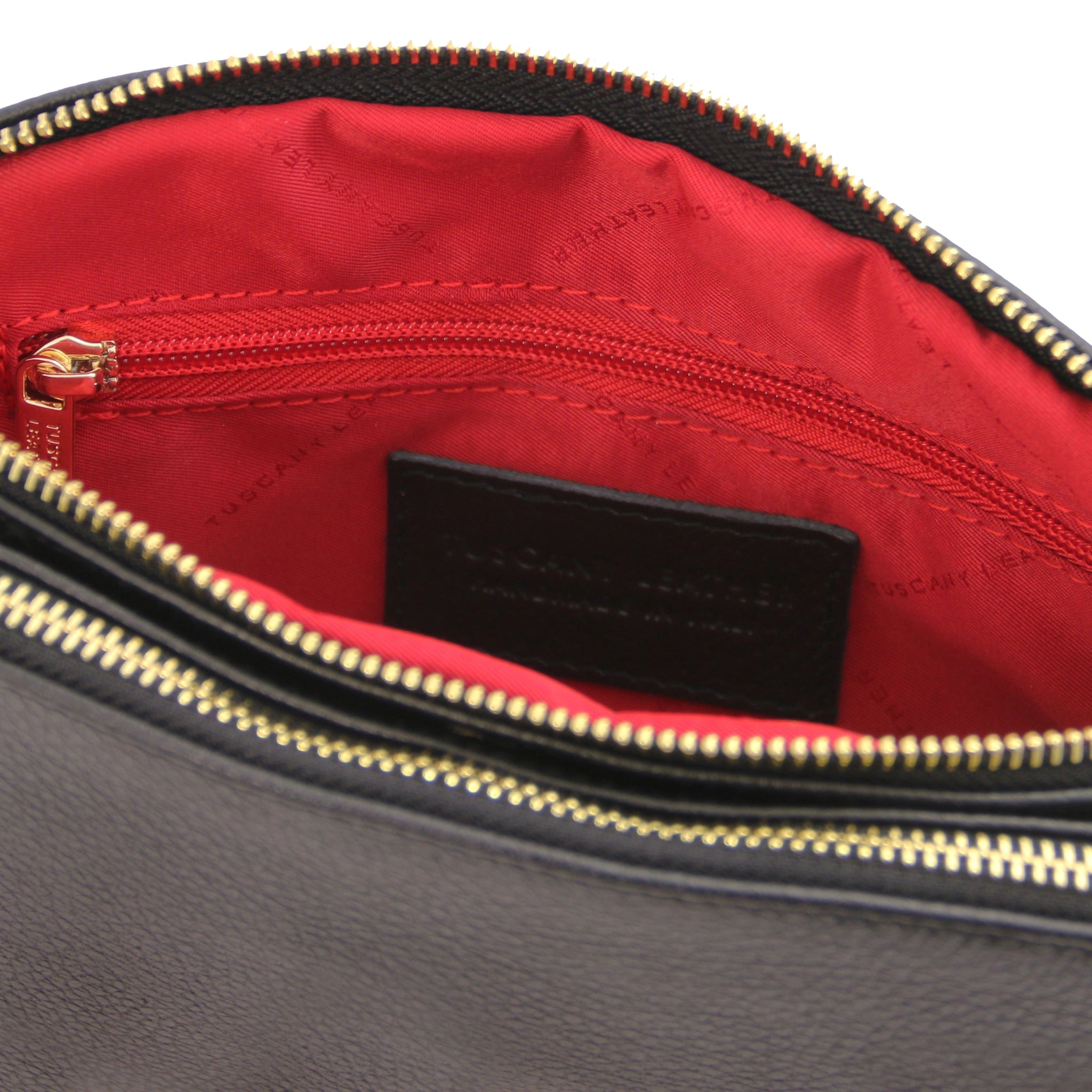 Interior zippered pocket view Lily Soft Italian Pebbled Leather Shoulder Bag in black showing vibrant red bag lining