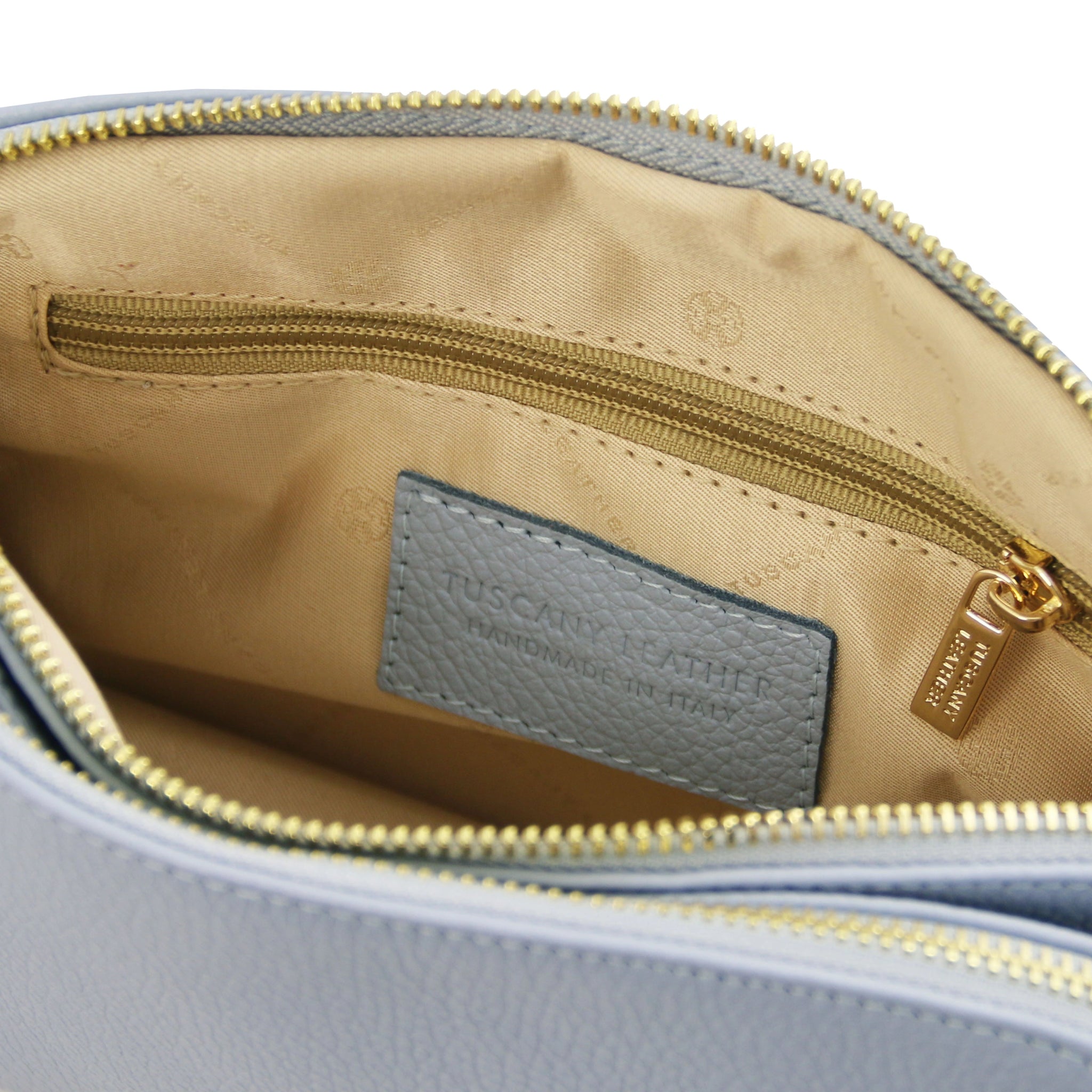 Interior zippered pocket view Lily Soft Italian Pebbled Leather Shoulder Bag in light blue showing beige bag lining