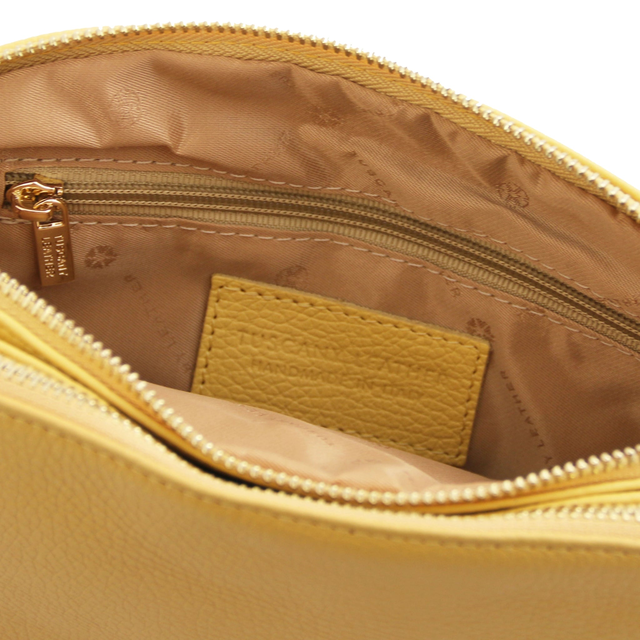 Interior zippered pocket view Lily Soft Italian Pebbled Leather Shoulder Bag in pastel yellow showing beige bag lining
