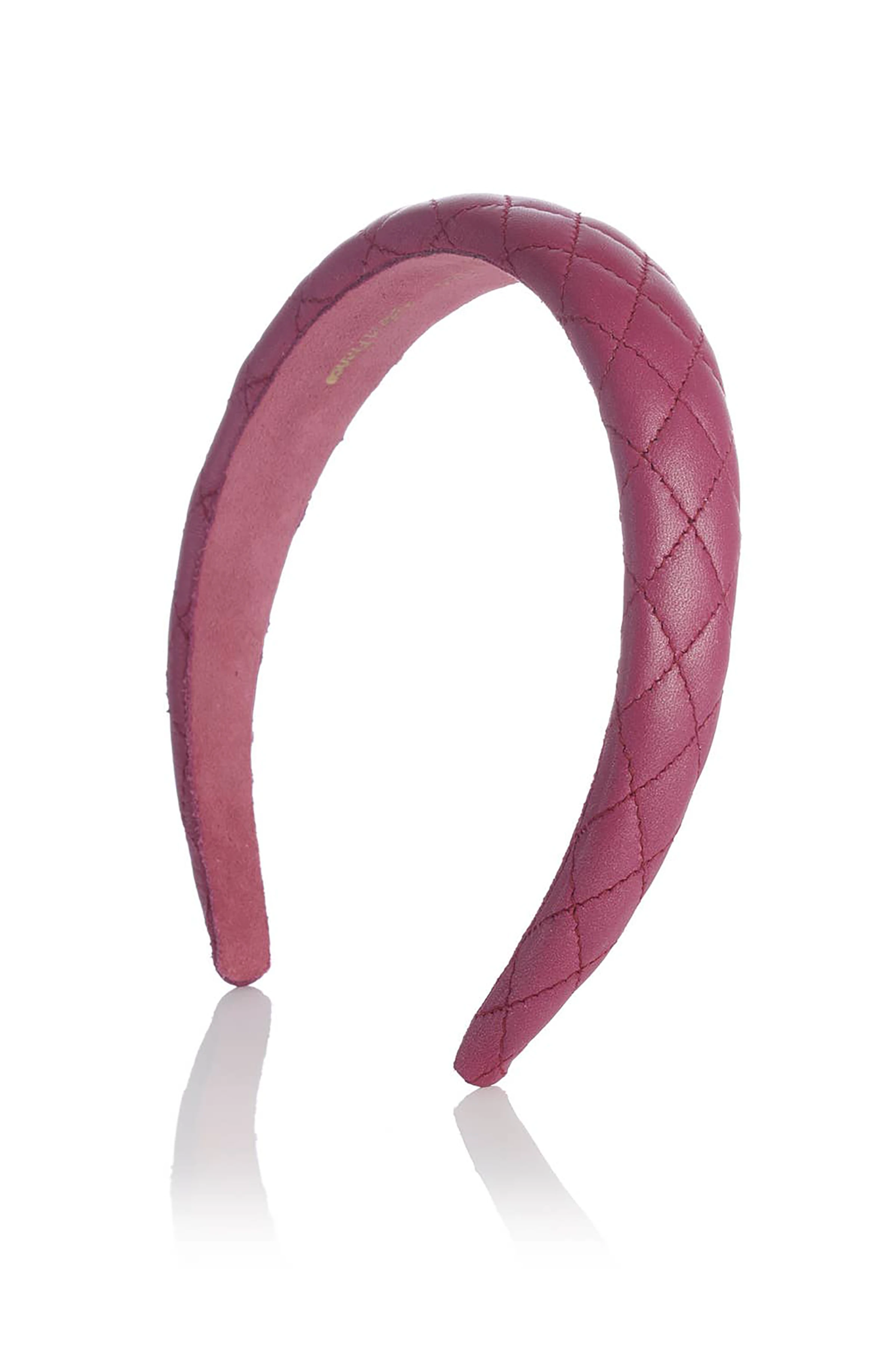 Pink quilted leather headband on a white background