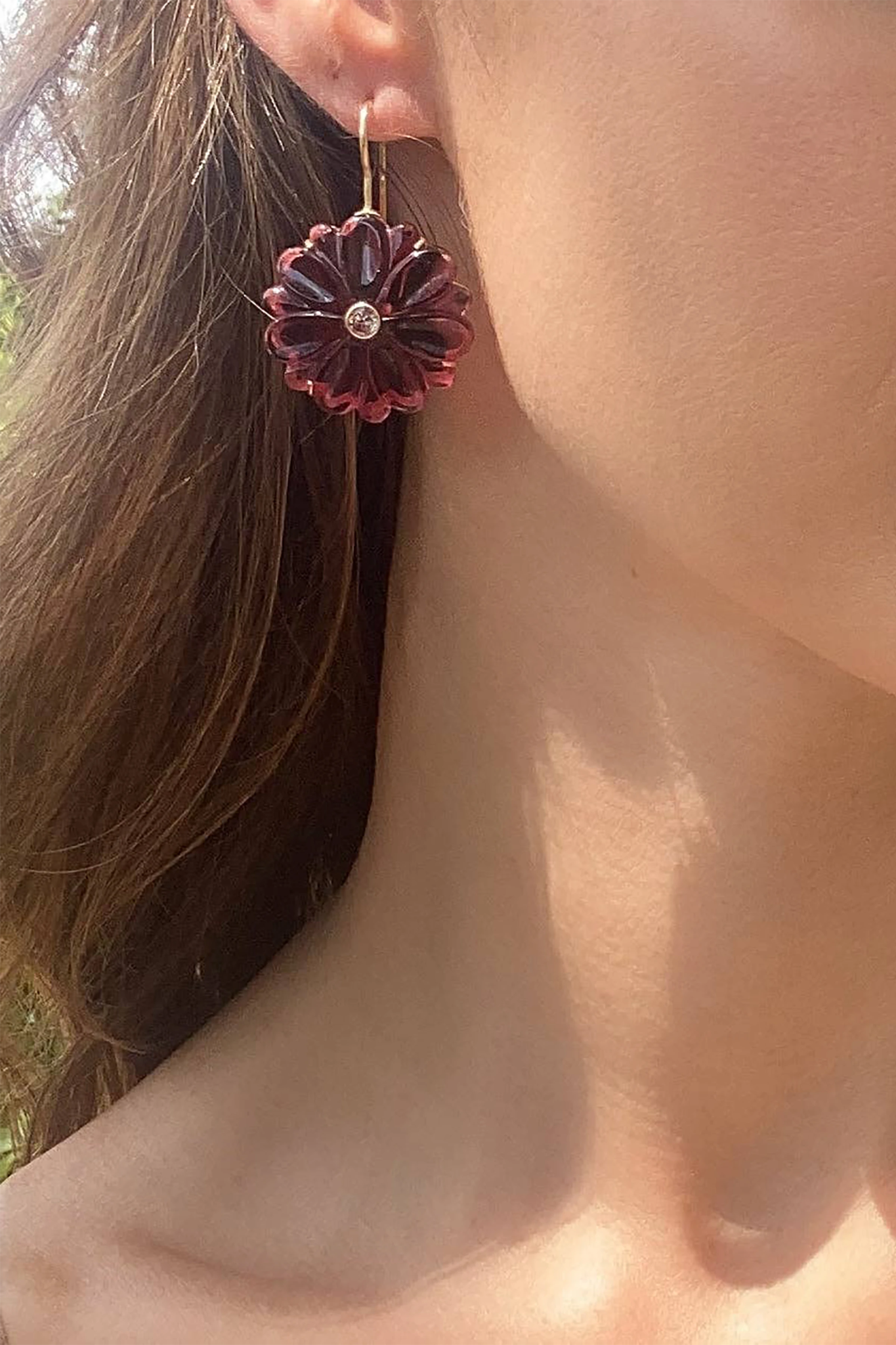 Magnolia White Agate Earrings on a model presented on her right ear and set in front of her long brown hair