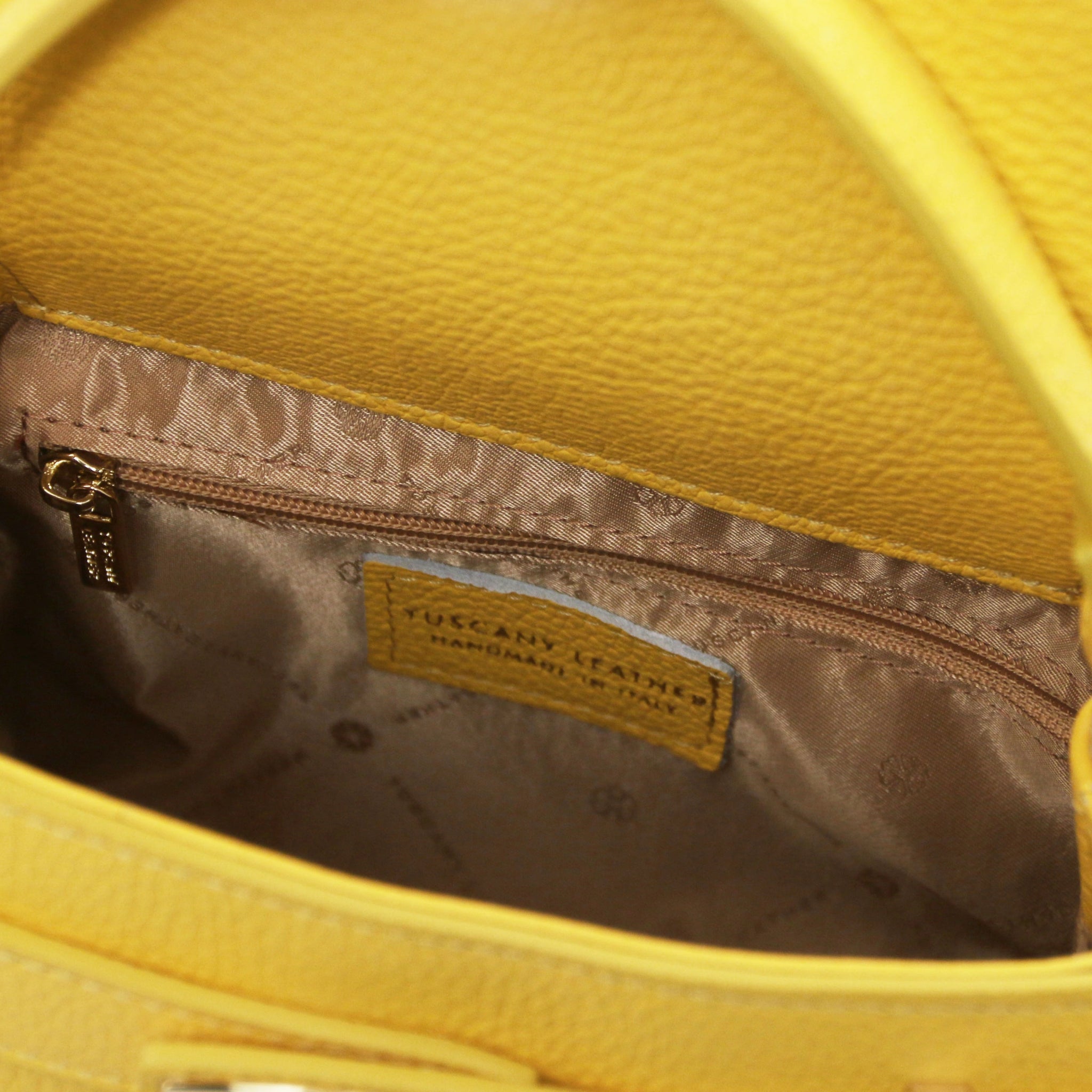 Interior open pocket view Maisy Italian Leather Small Tote Bag in pastel yellow showing beige lining