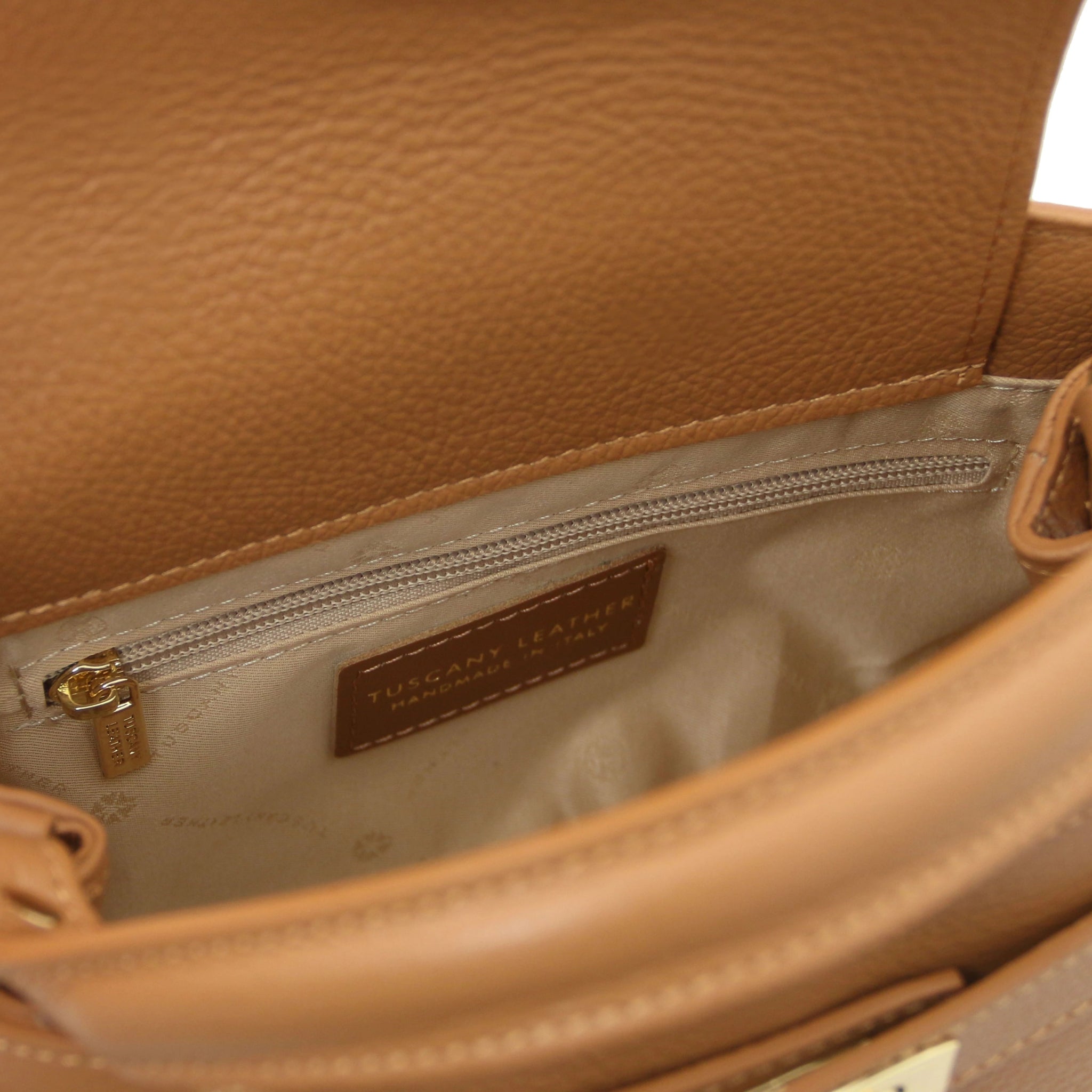 Interior Zip Pocket View Maisy Italian Leather Small Tote Bag in Caramel showing beige lining