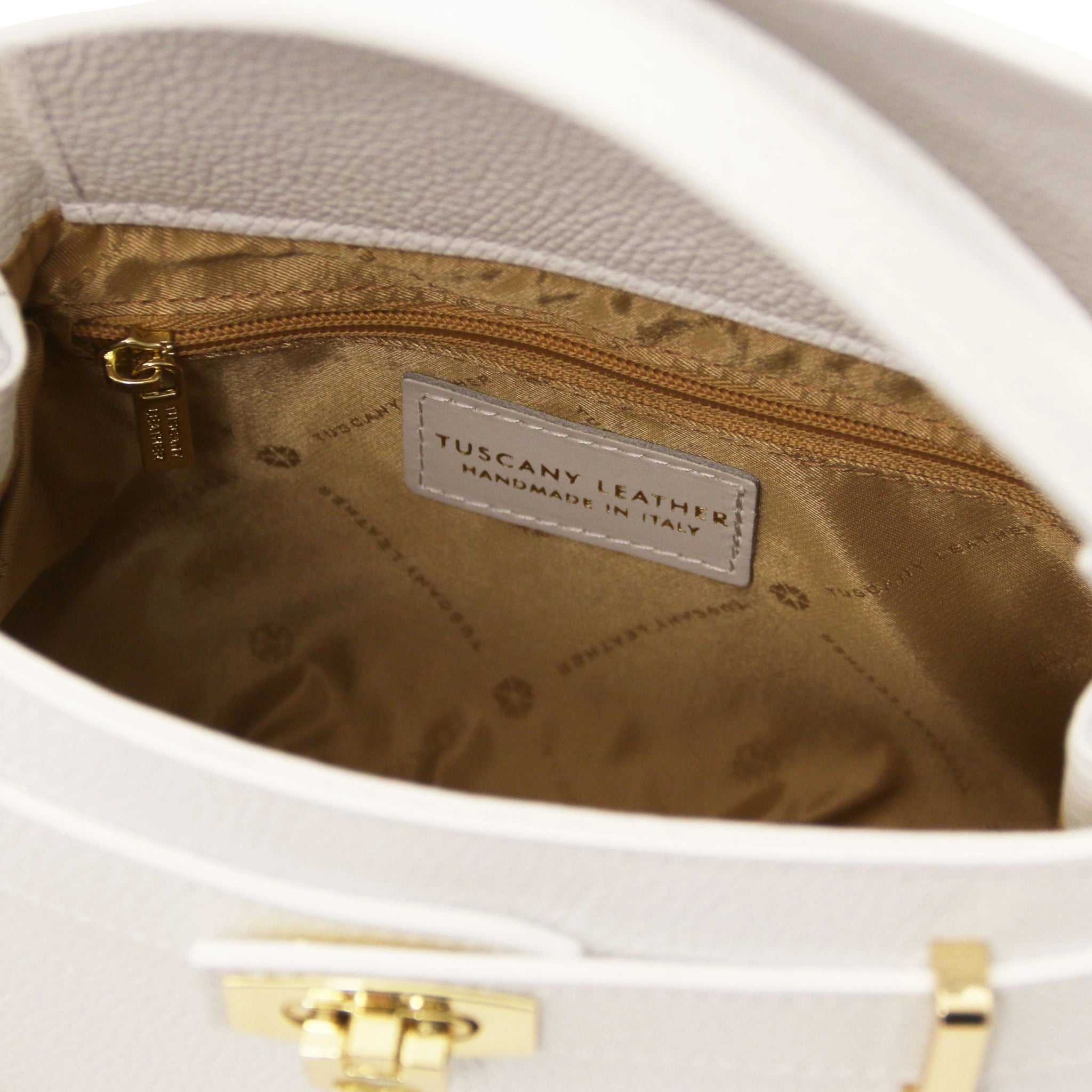 Interior zippered view Maisy Italian Leather Small Tote Bag in white showing beige interior and Tuscany Leather logo
