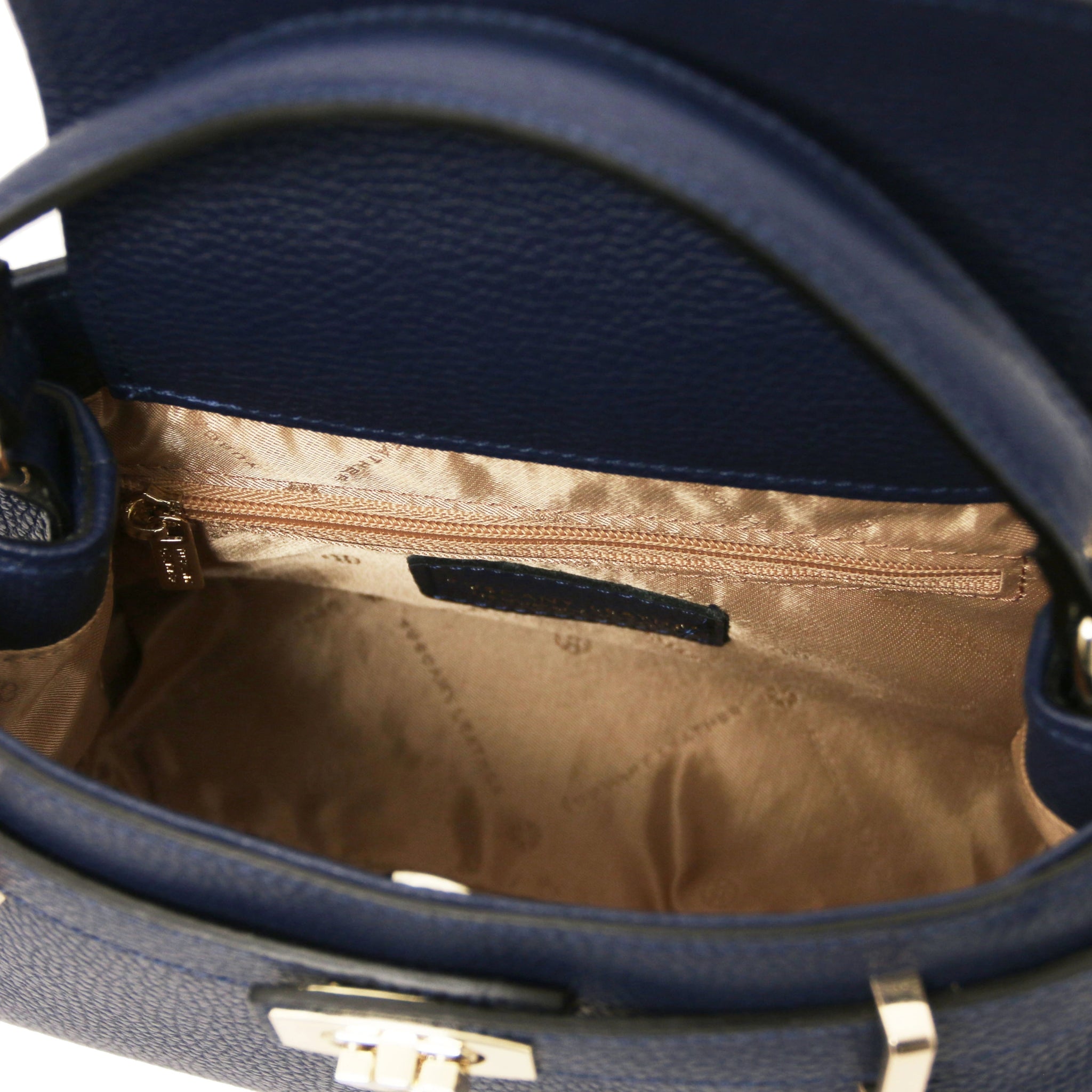 Interior Zip Pocket View Maisy Italian Leather Small Tote Bag in dark blue showing beige lining