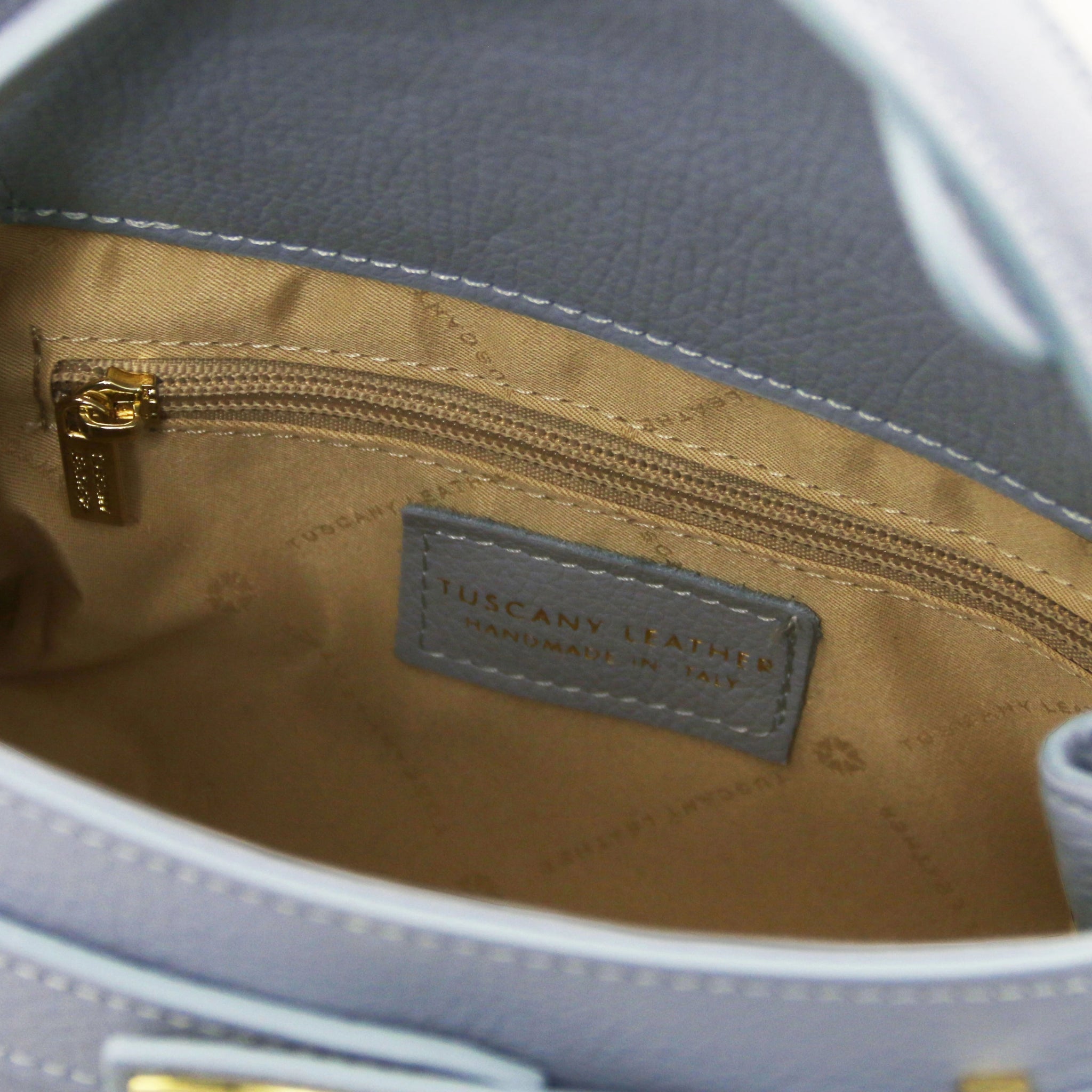 Interior zippered pocket view Maisy Italian Leather Tote Bag in Light Blue showing the red bag lining