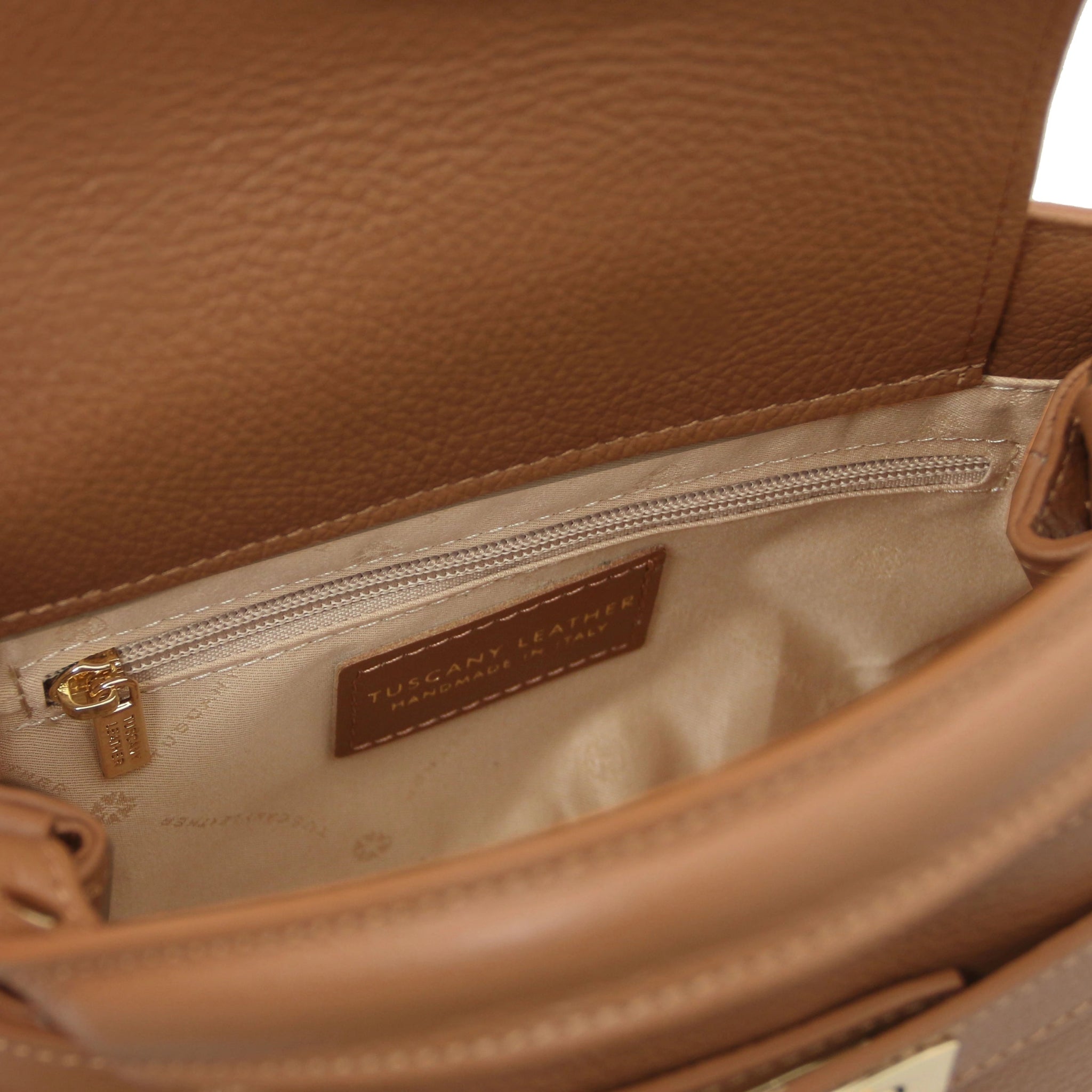 Interior zippered pocket view Maisy Italian Leather Tote Bag in Caramel with beige bag lining