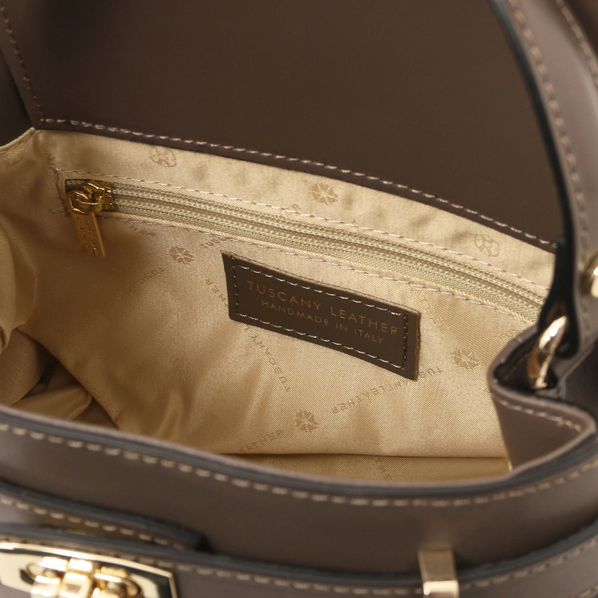 Interior zippered pocket view Maisy Italian Leather Tote Bag in Dark Taupe showing the beige bag lining