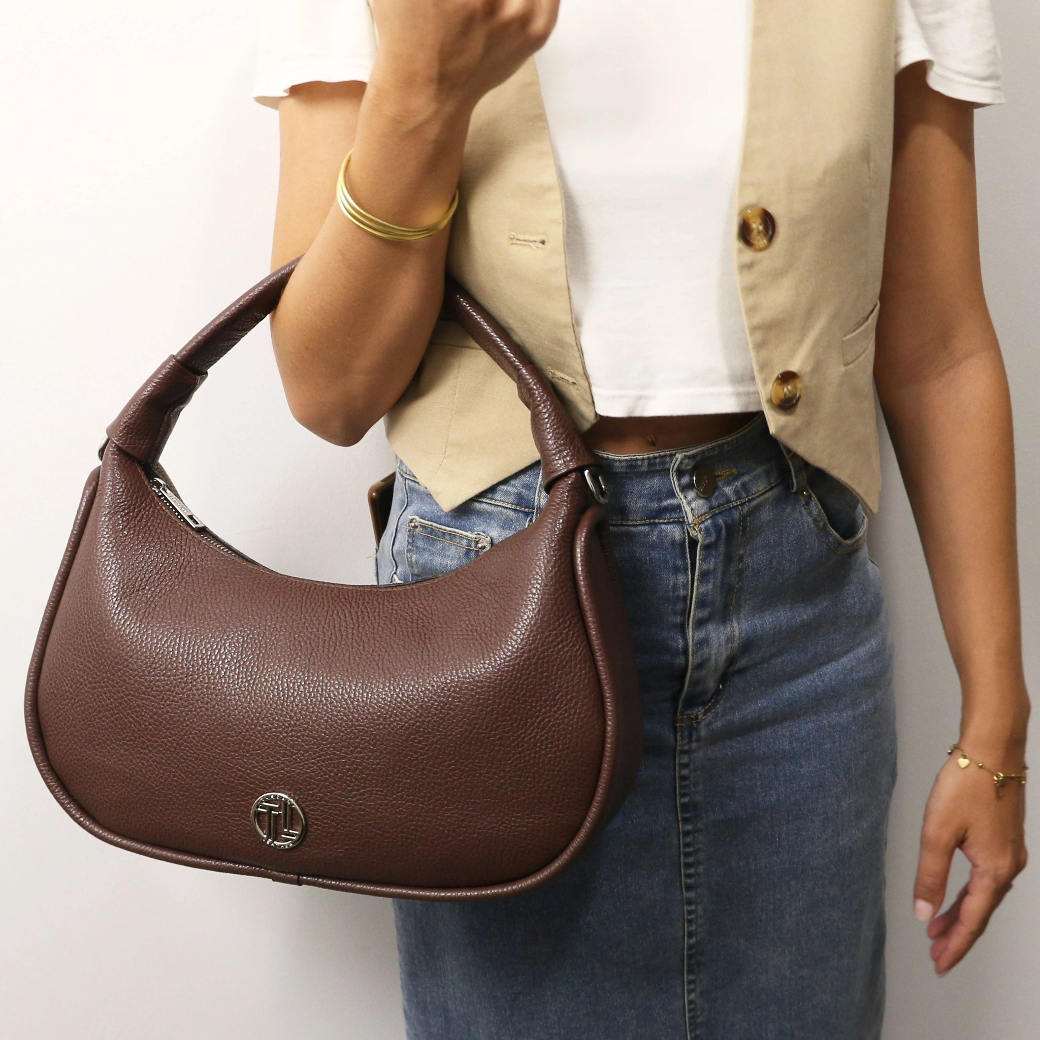 Model holding Michelle Pebbled Leather Hobo Bag in coffee on her arm