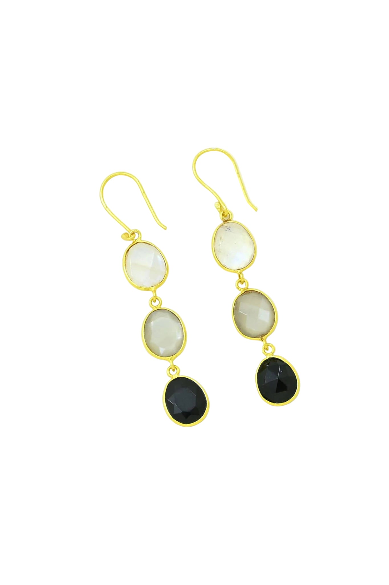 Gold earrings with black, gray and white oval stones on a light background