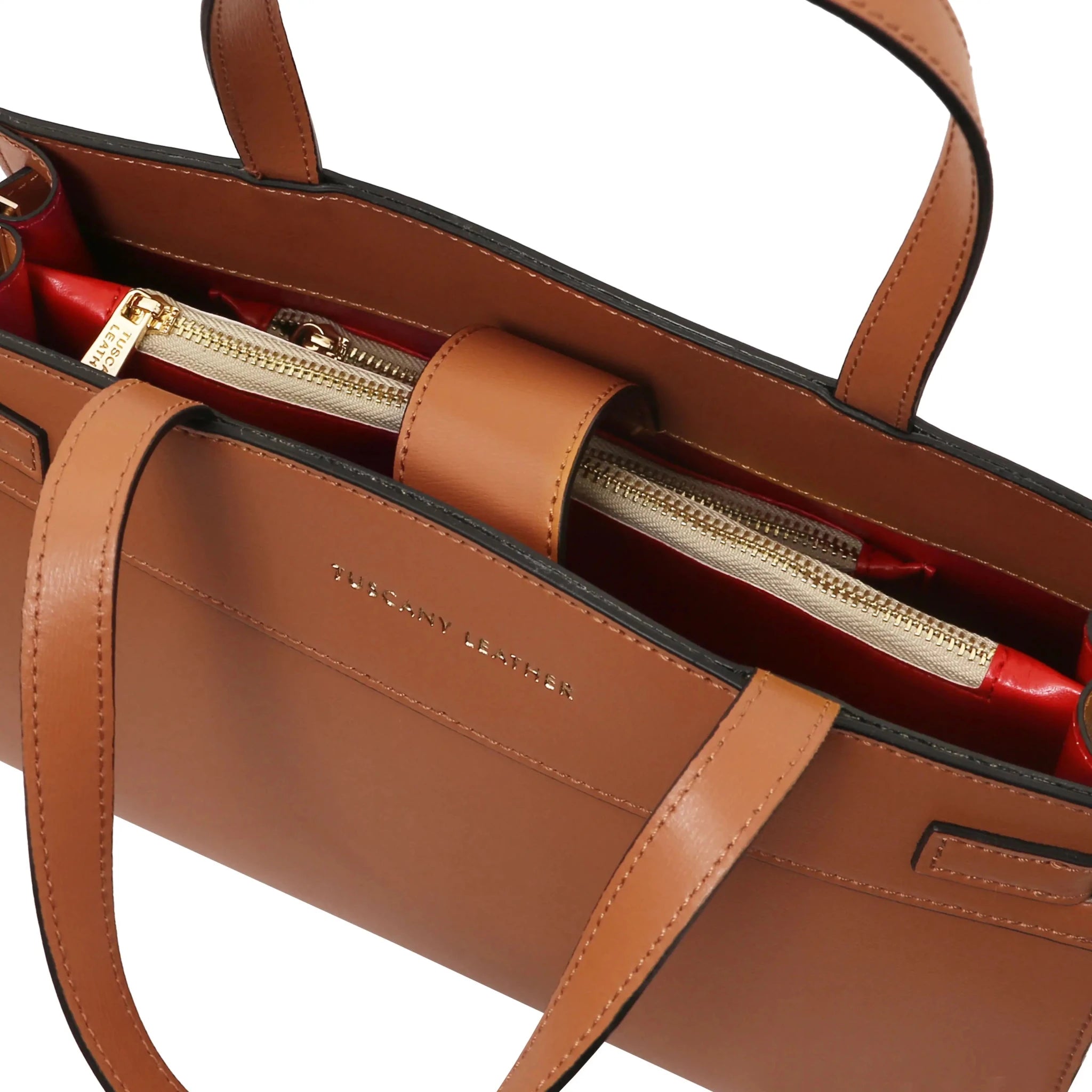 Interior zip pockets and magnetic closure view Musa Italian Smooth Leather Tote Bag in cognac with red lining