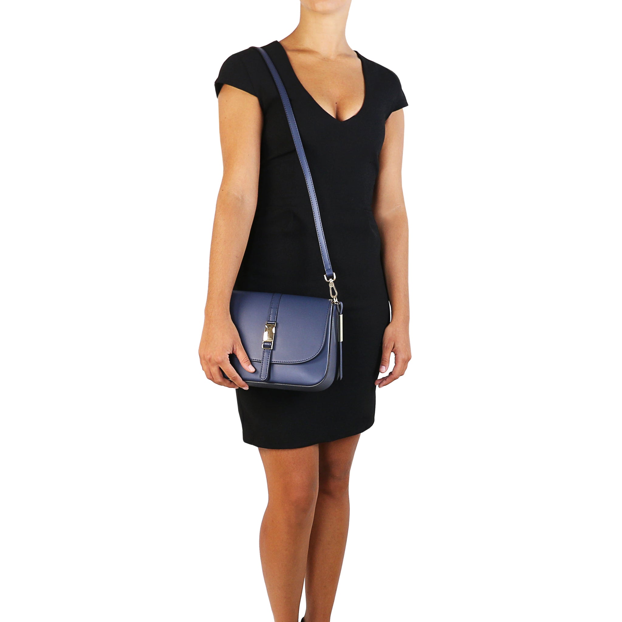 Model wearing Nausica Leather Shoulder Bag in Dark Blue on shoulder by detachable, adjustable crossbody strap for casual wear