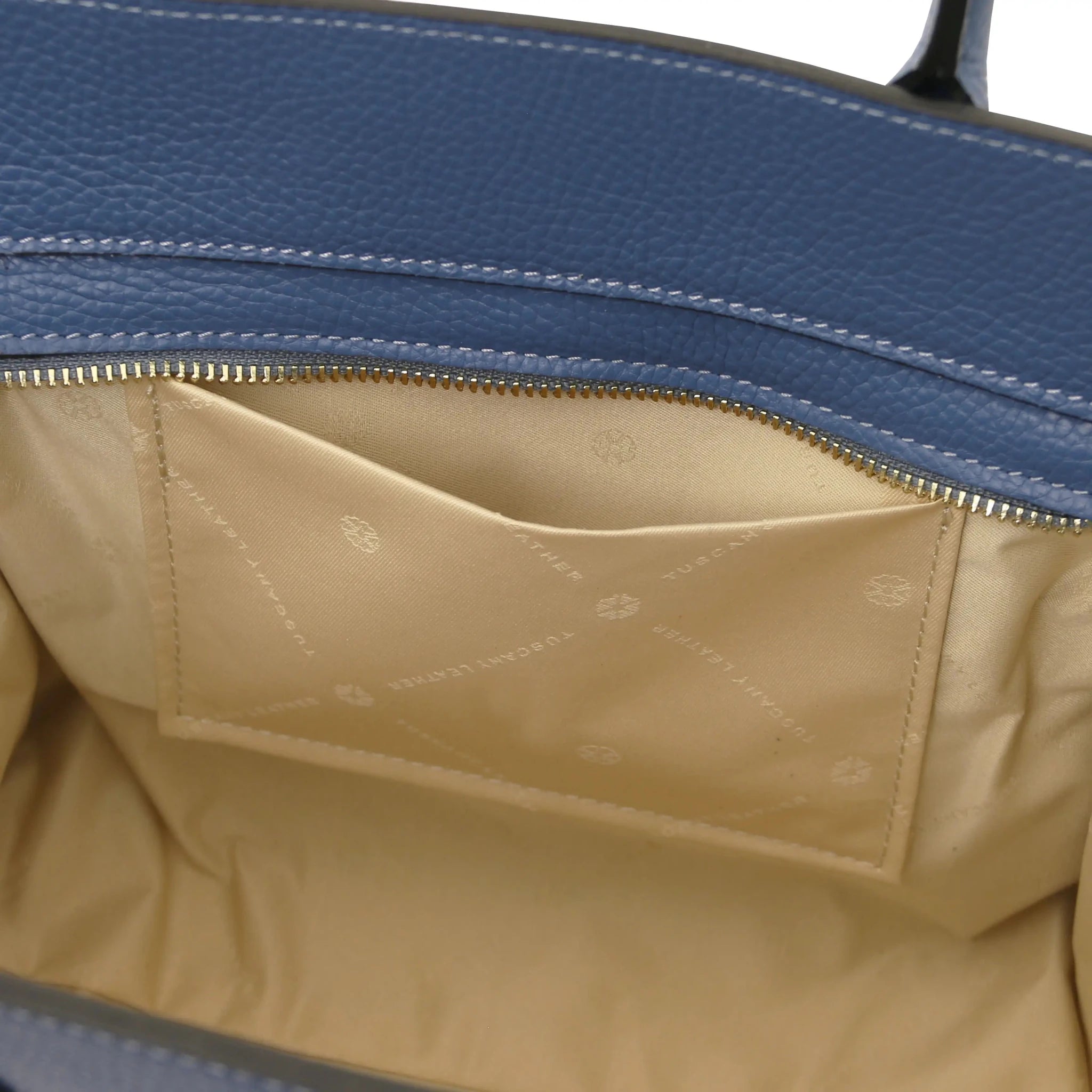 Interior open pocket view Origami Italian Pebbled Leather Tote in denim with beige lining