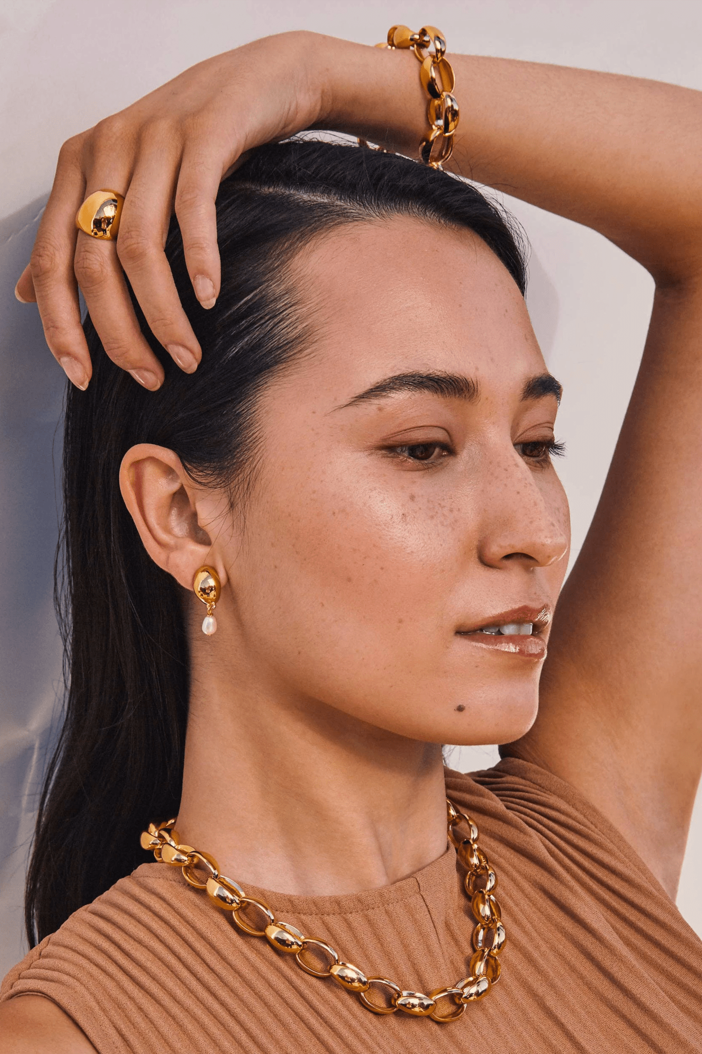 Woman wearing Origin Chainlink Gold Collar bracelet and necklace.