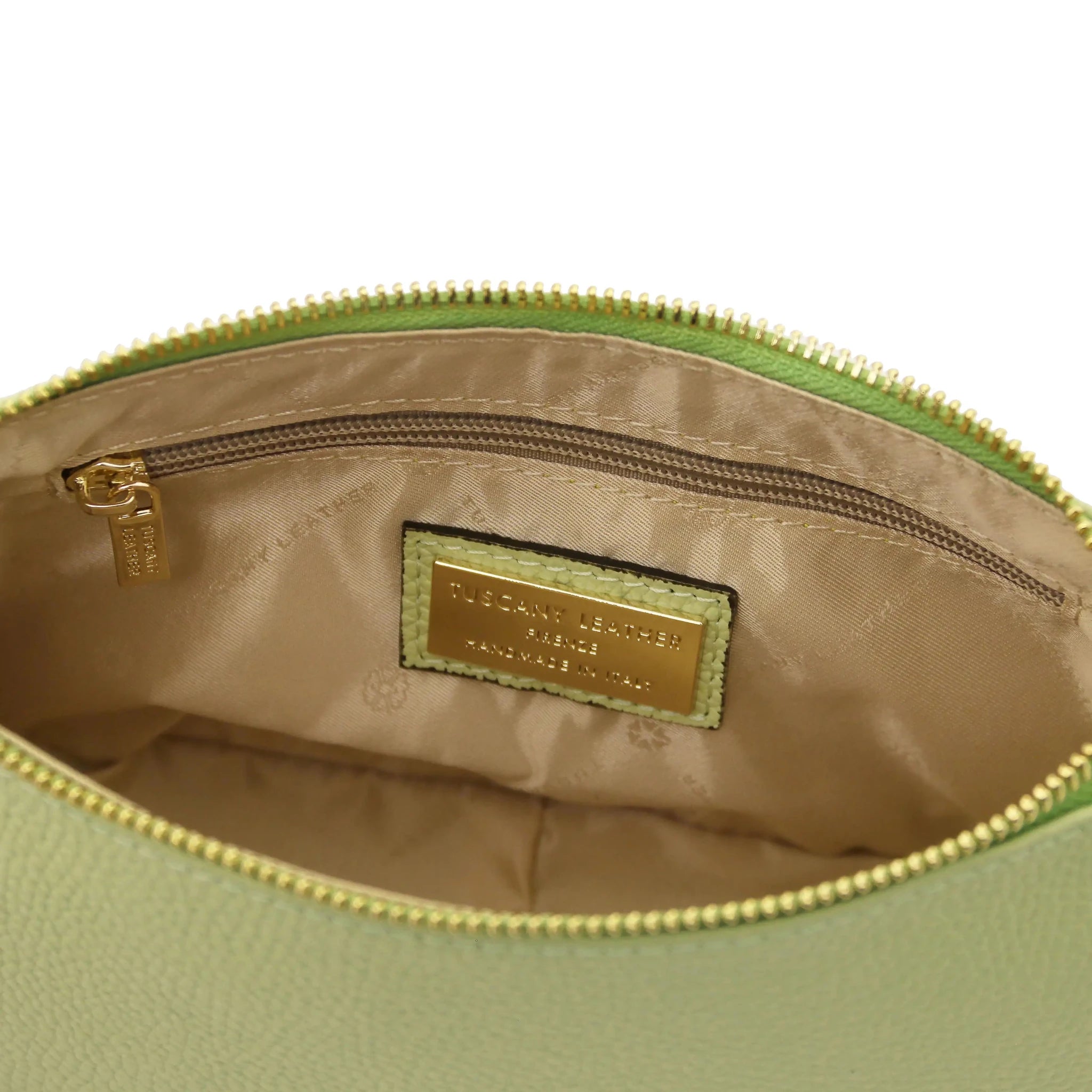 Interior zip pocket view Parfait Leather Clutch in lime green with beige lining on white background