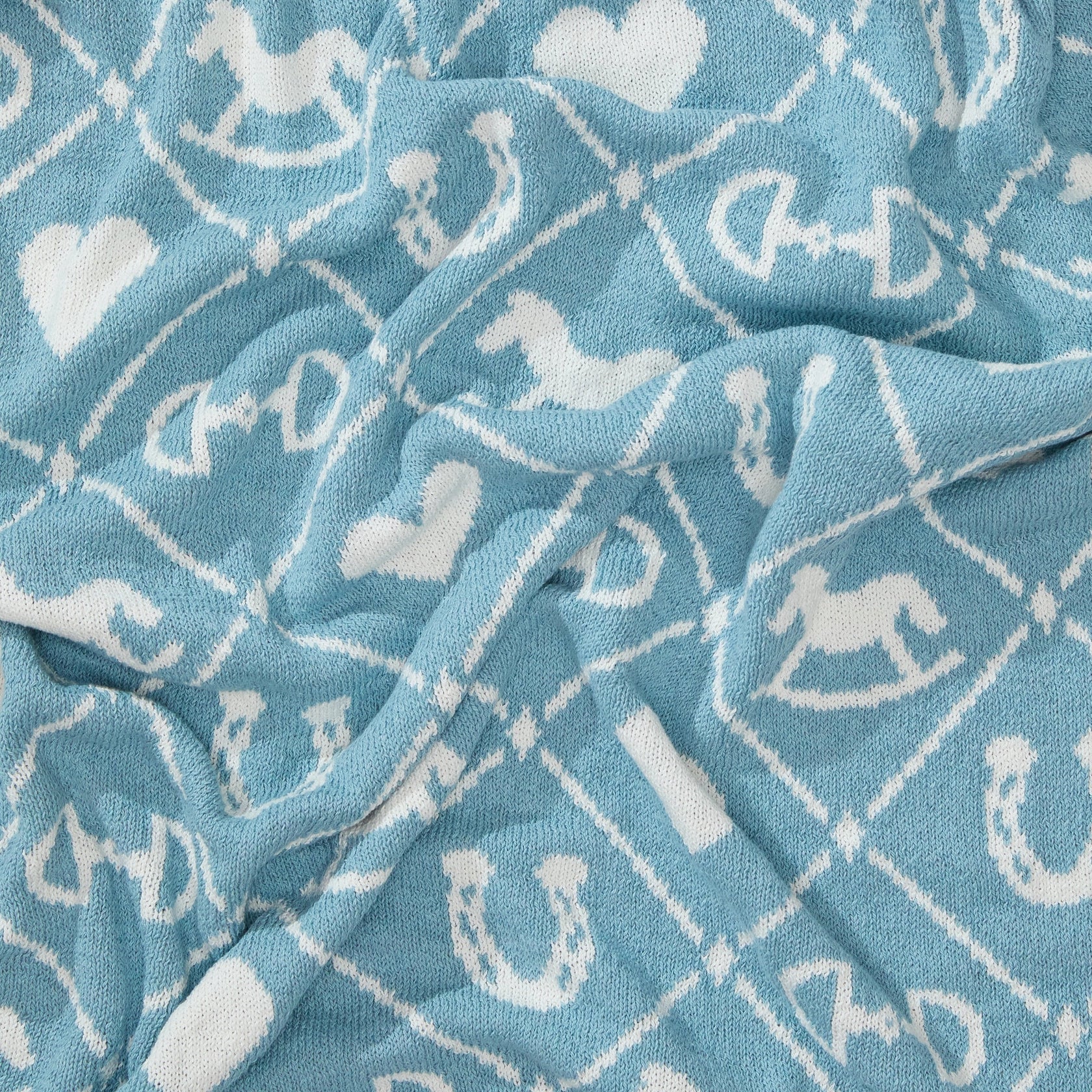 Pony Dreams Reversible Throw in Pink Blue close up view of the pattern.