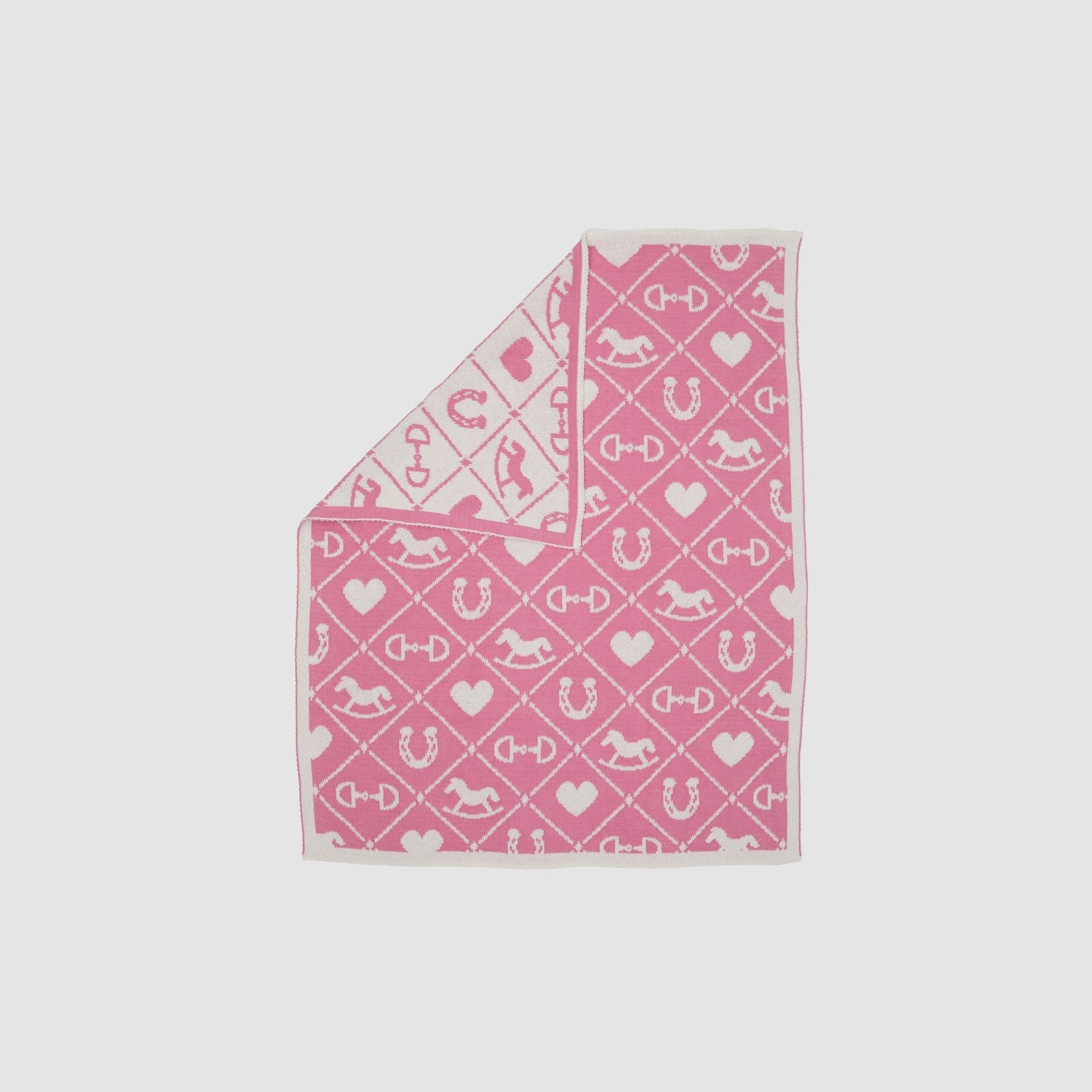 Pony Dreams Reversible Throw in Pink on a white background showing the whte reversible side.