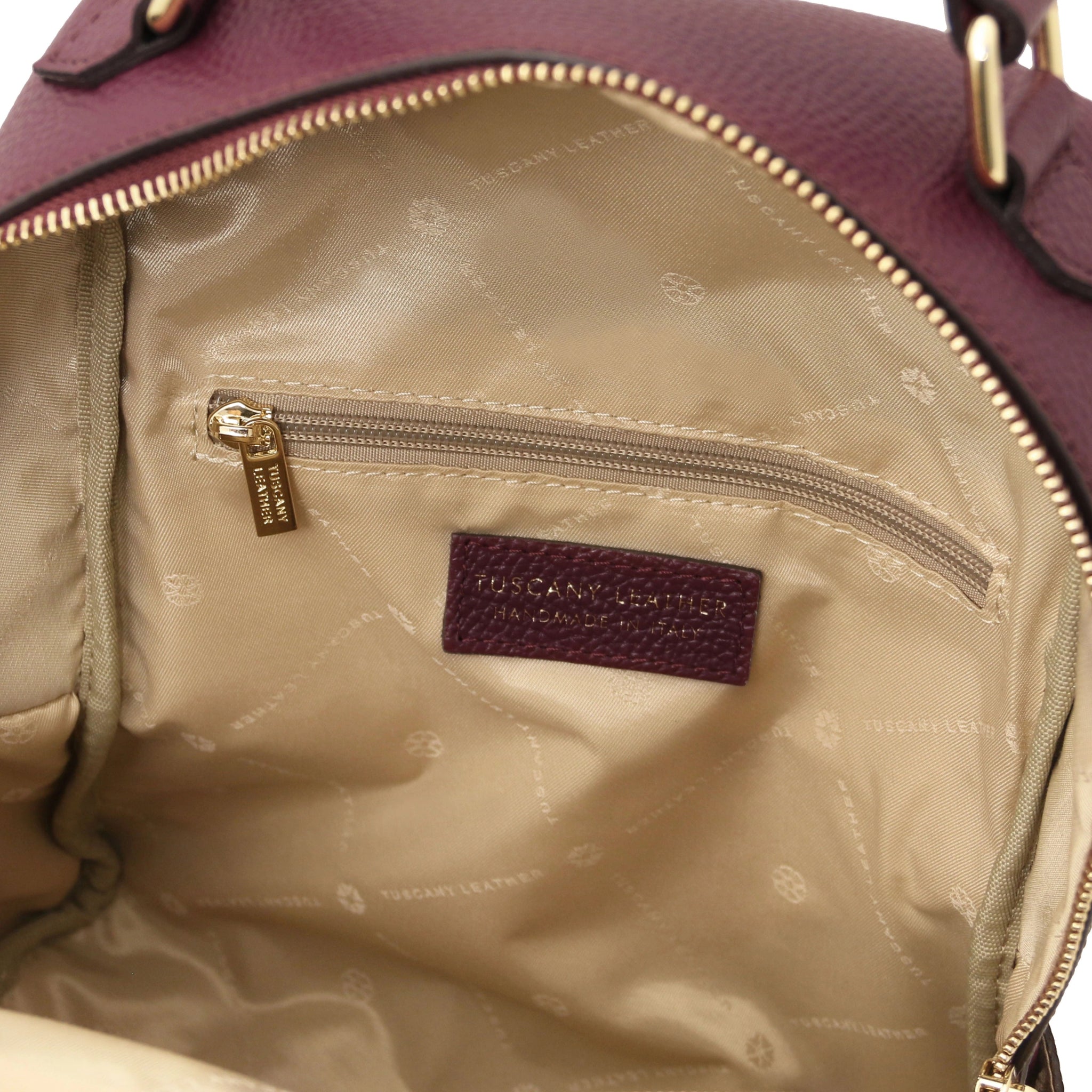Interior zip pocket view Prisma Leather Backpack in Bordeaux with beige lining