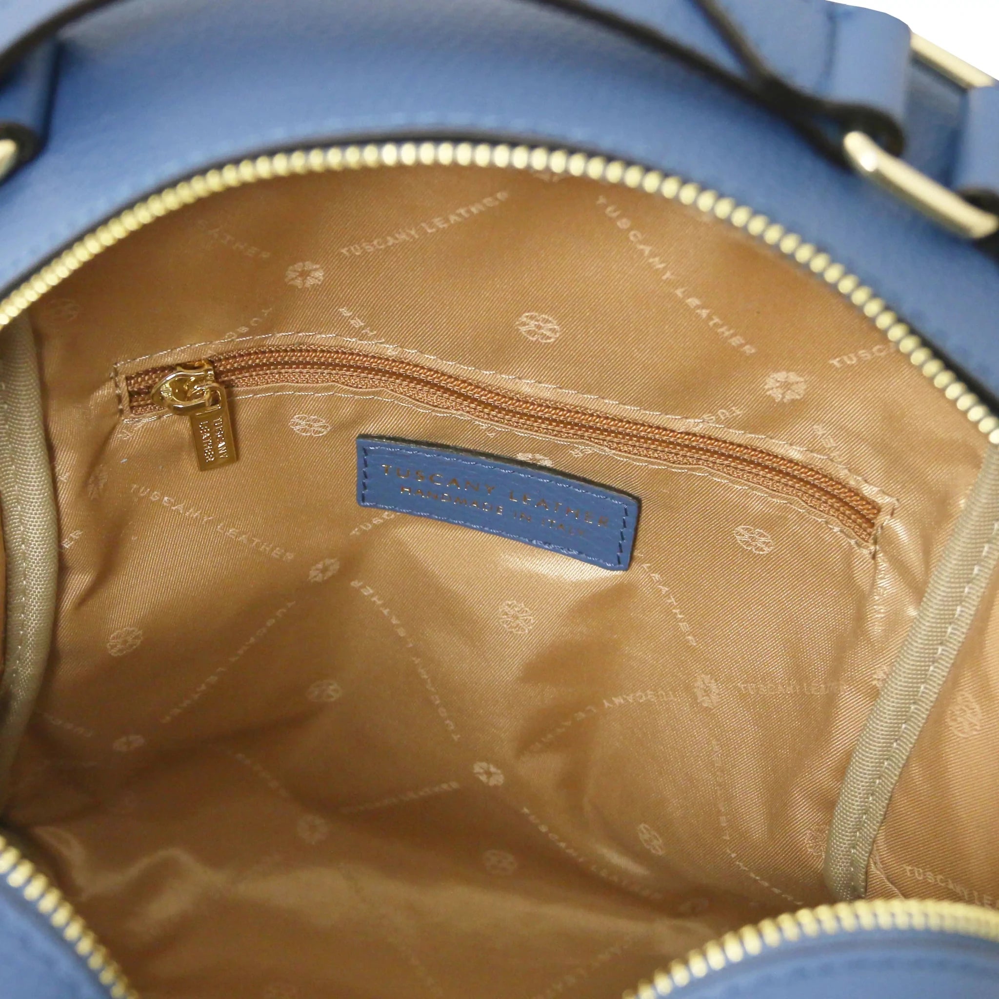 Interior zip pocket view Prisma Leather Backpack in denim with beige lining