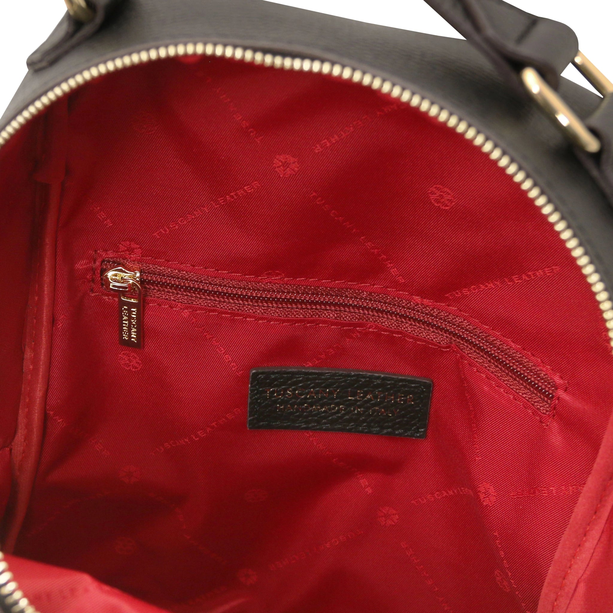 Interior zip pocket view Prisma Leather Backpack in black with red lining