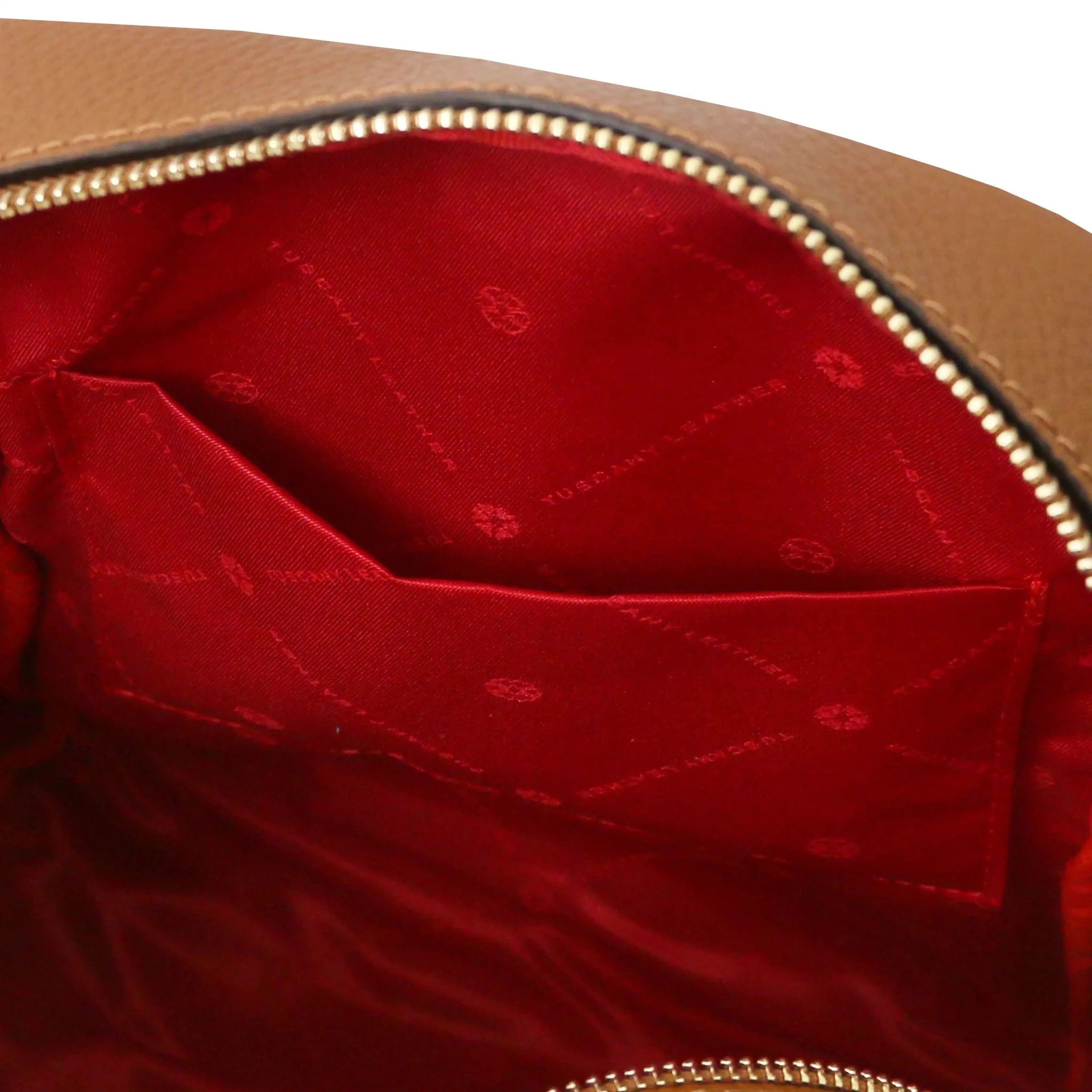 Interior open pocket view Prisma Leather Backpack in cognac with red lining