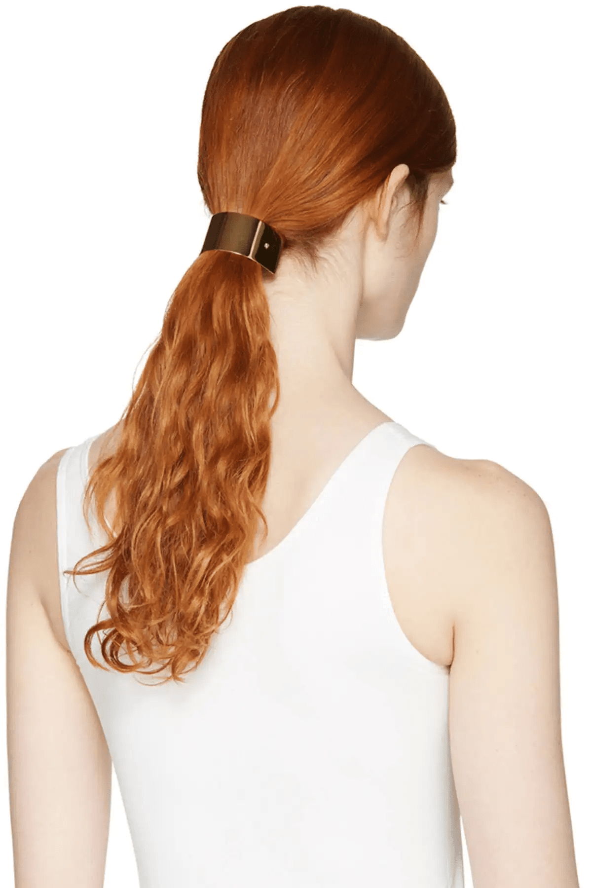 Woman with red hair tied in a ponytail wearing a gold barrette on a white background