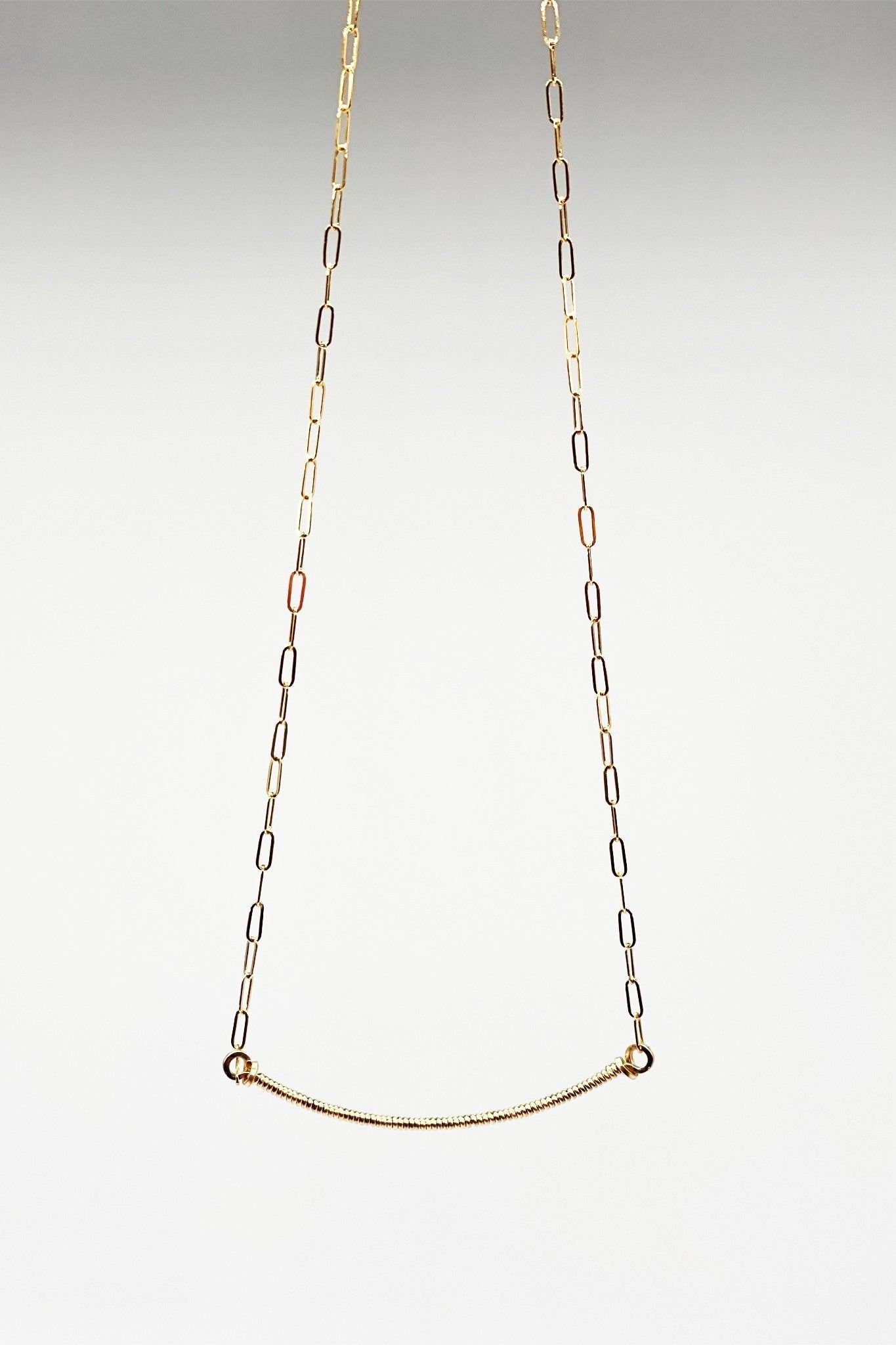 Signature Wrap U Necklace in Gold on a light gray background - L'Atelier Global