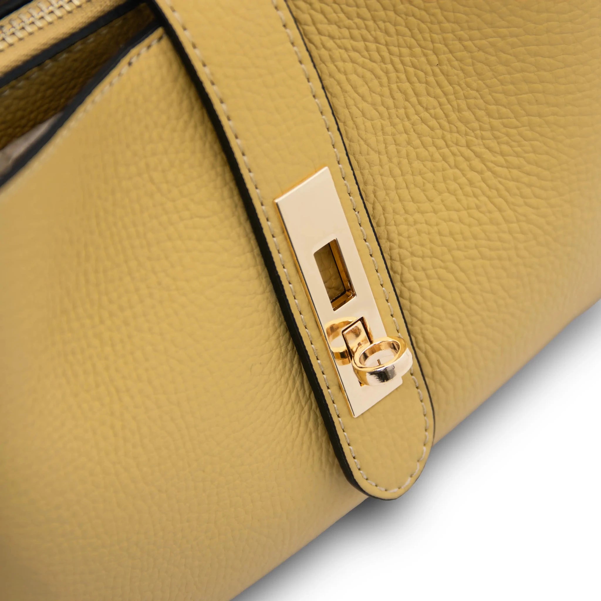 Close up twist lock view Soave Soft Leather Handbag in light blue on white background