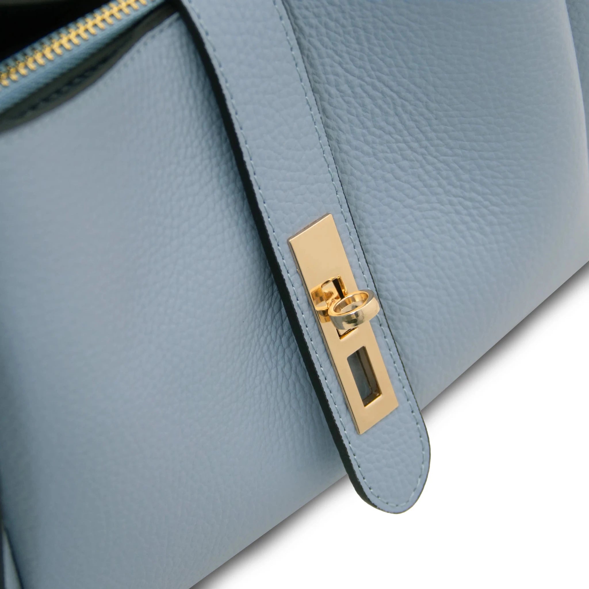 Front angled close up view Soave Soft Leather Handbag in light blue showing metal twist lock gold hardware