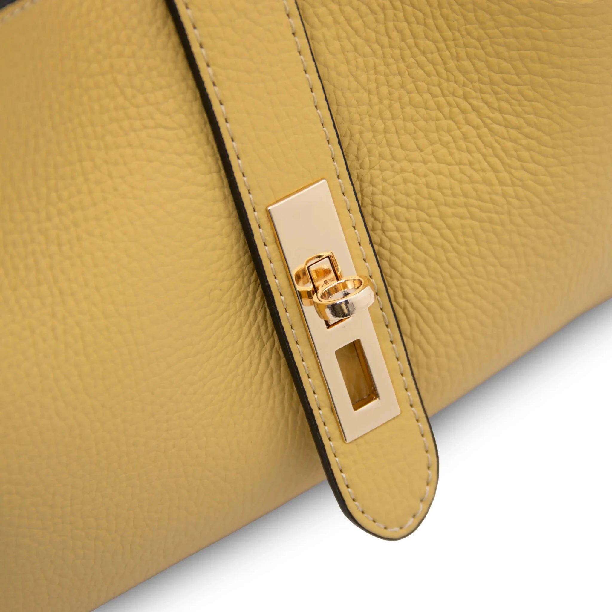 Close up twist lock opened view Soave Soft Leather Handbag in yellow on white background