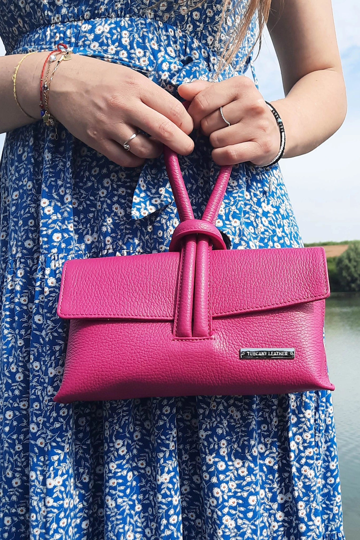 Female model holding the TL Bag Italian Leather Clutch in pink