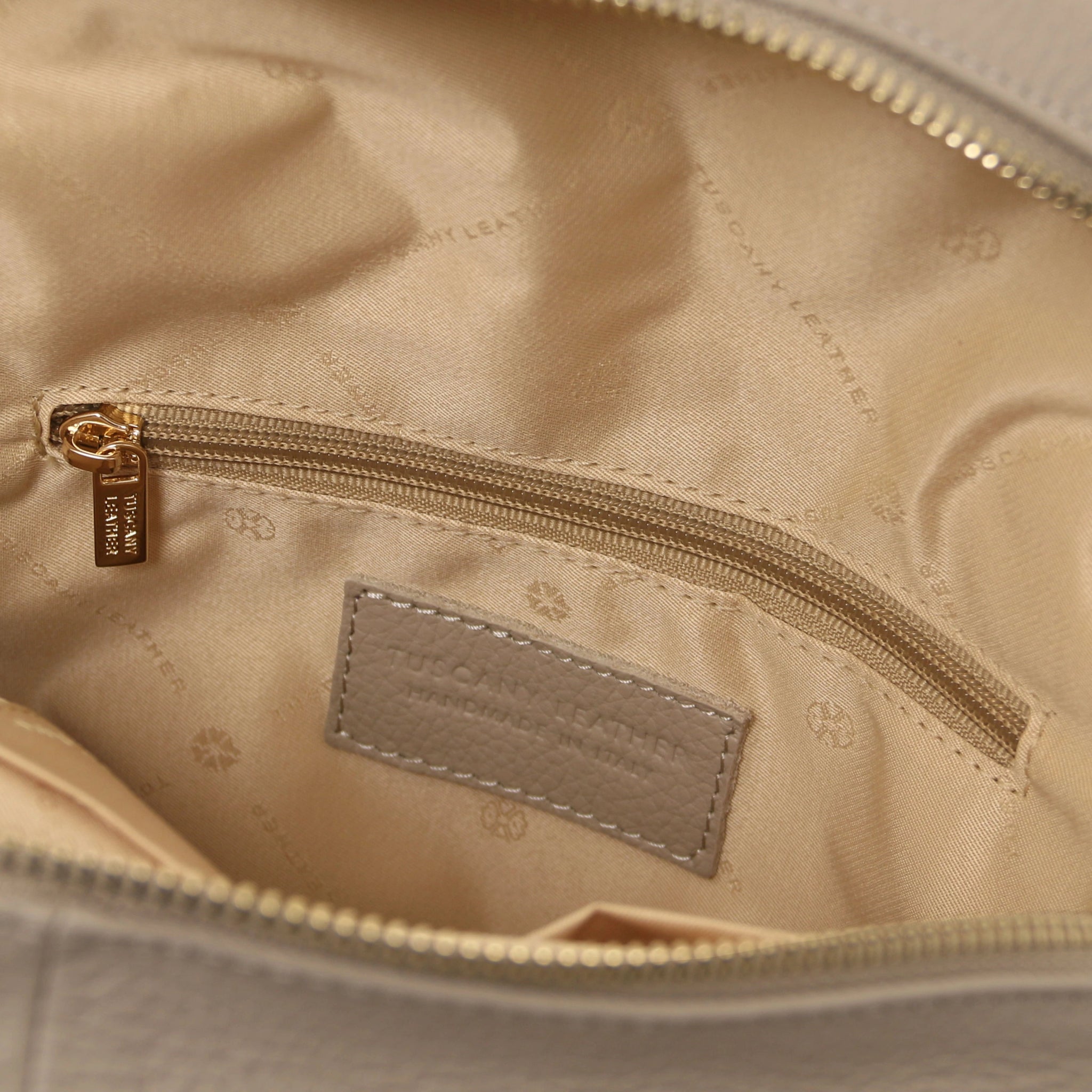Interior zip pocket view TL Bag Italian Soft Leather Zip Backpack in light. taupe showing beige lining