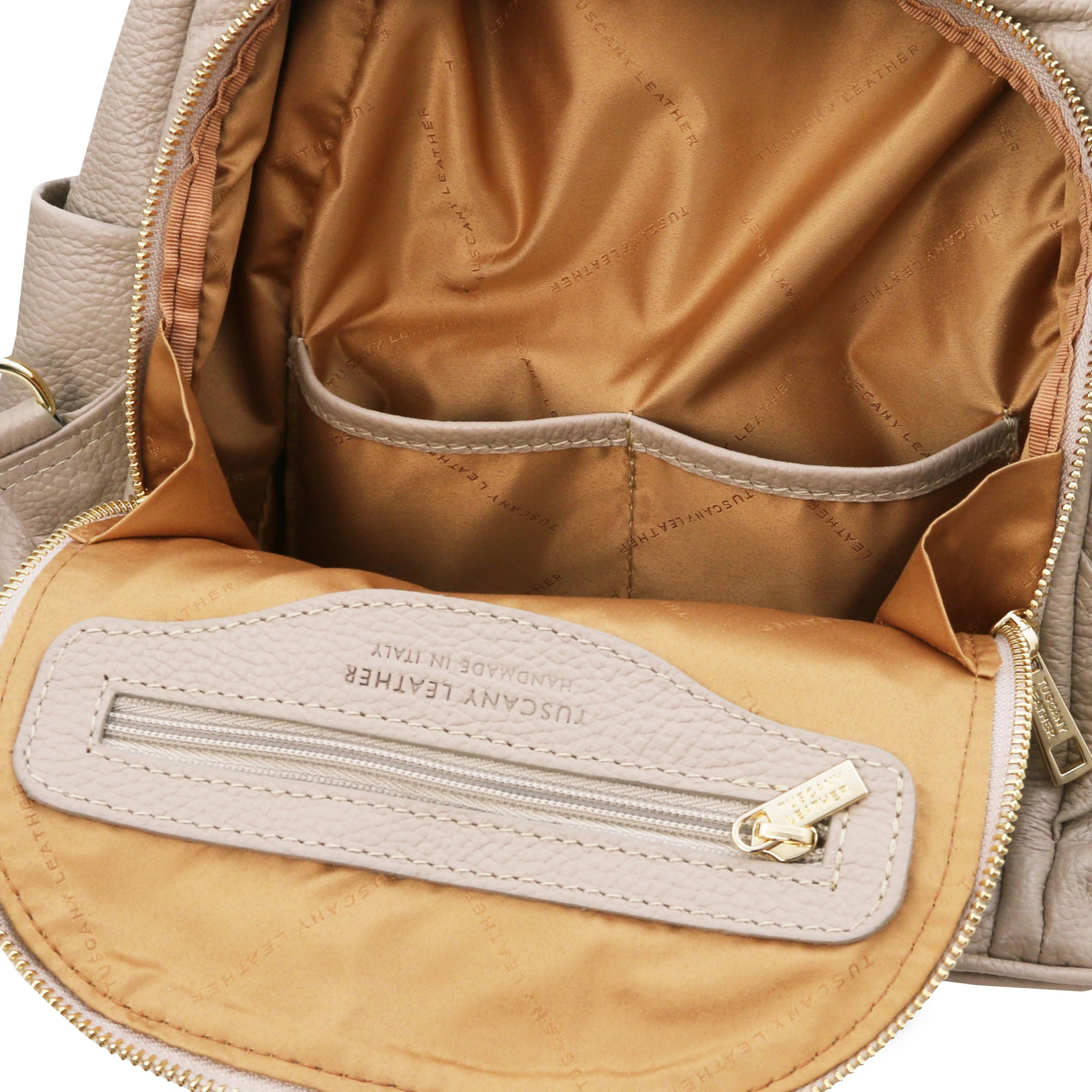 TL Bag Soft Leather Backpack in light taupe showing Front exterior zip compartment two open and one zipper pockets, with camel lining