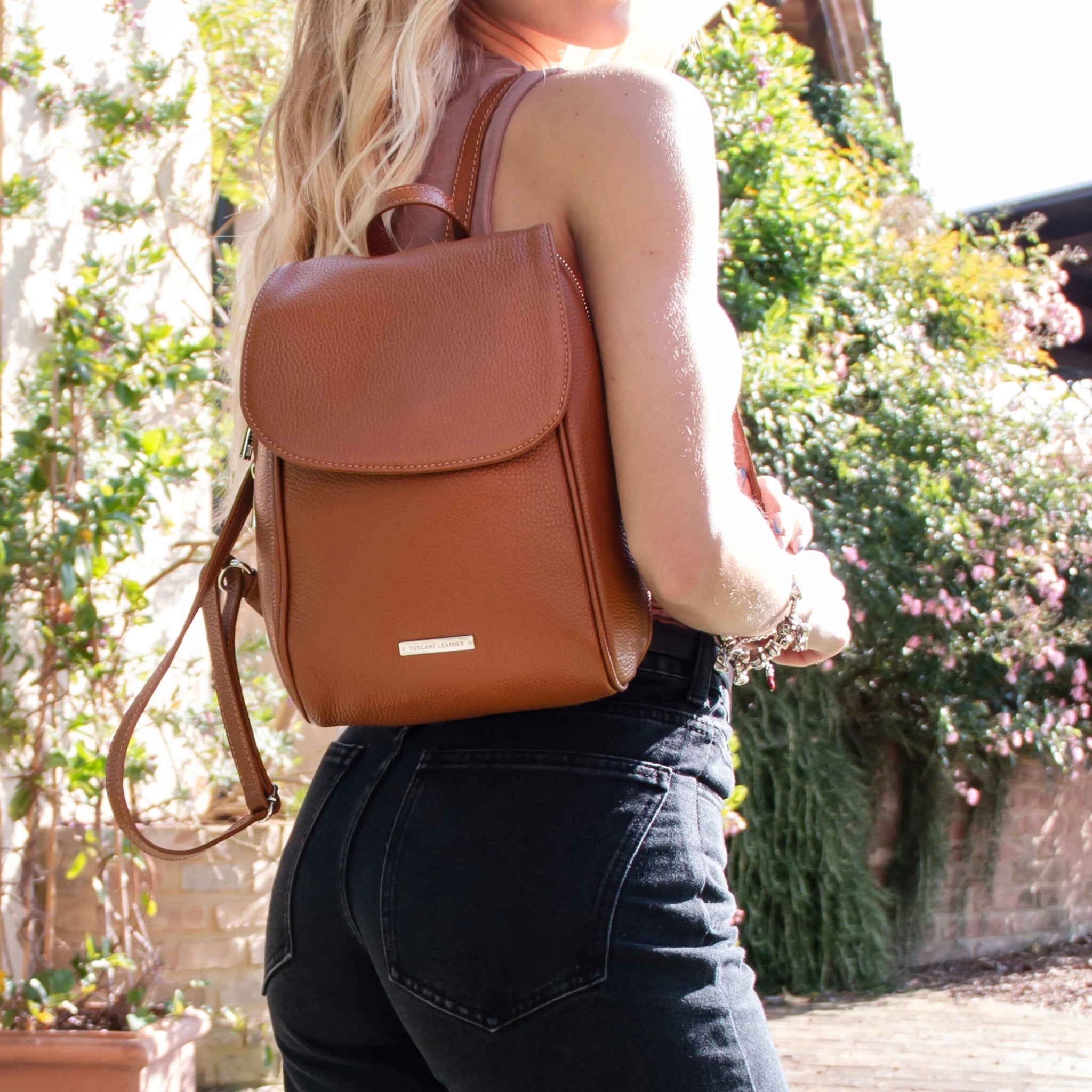 Model wearing the TL Bag Soft Italian Leather Backpack in Cognac over one shoulder