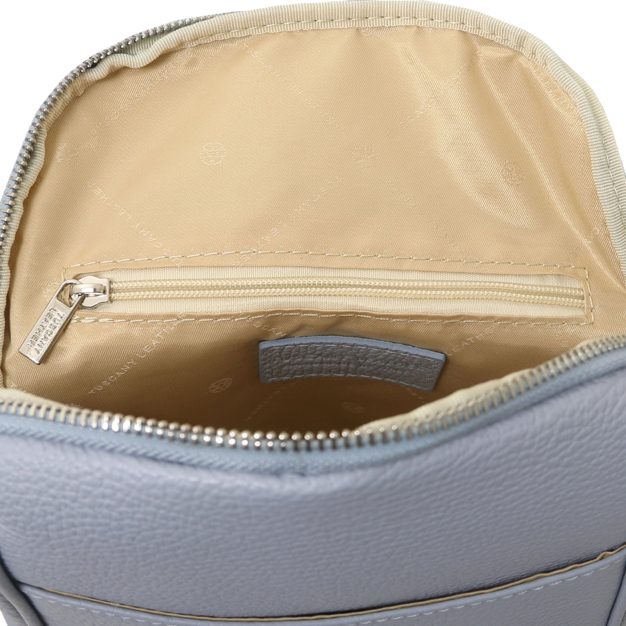 Leather Backpack in Light Blue interior zip pocket view showing beige lining