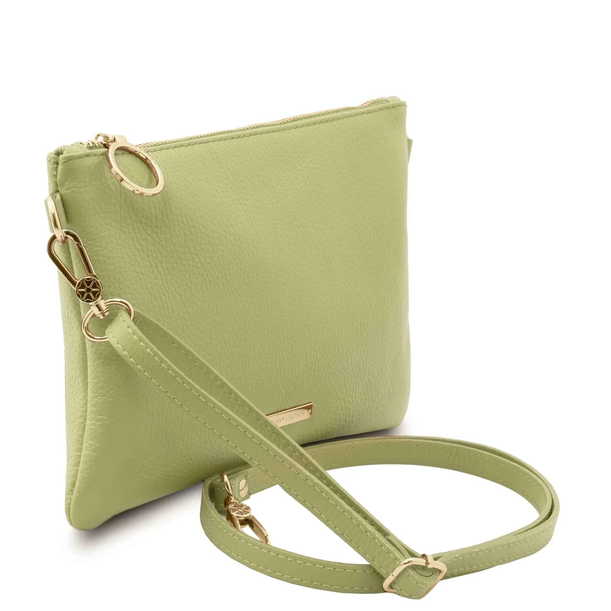 Green crossbody bag with gold accents on a white background