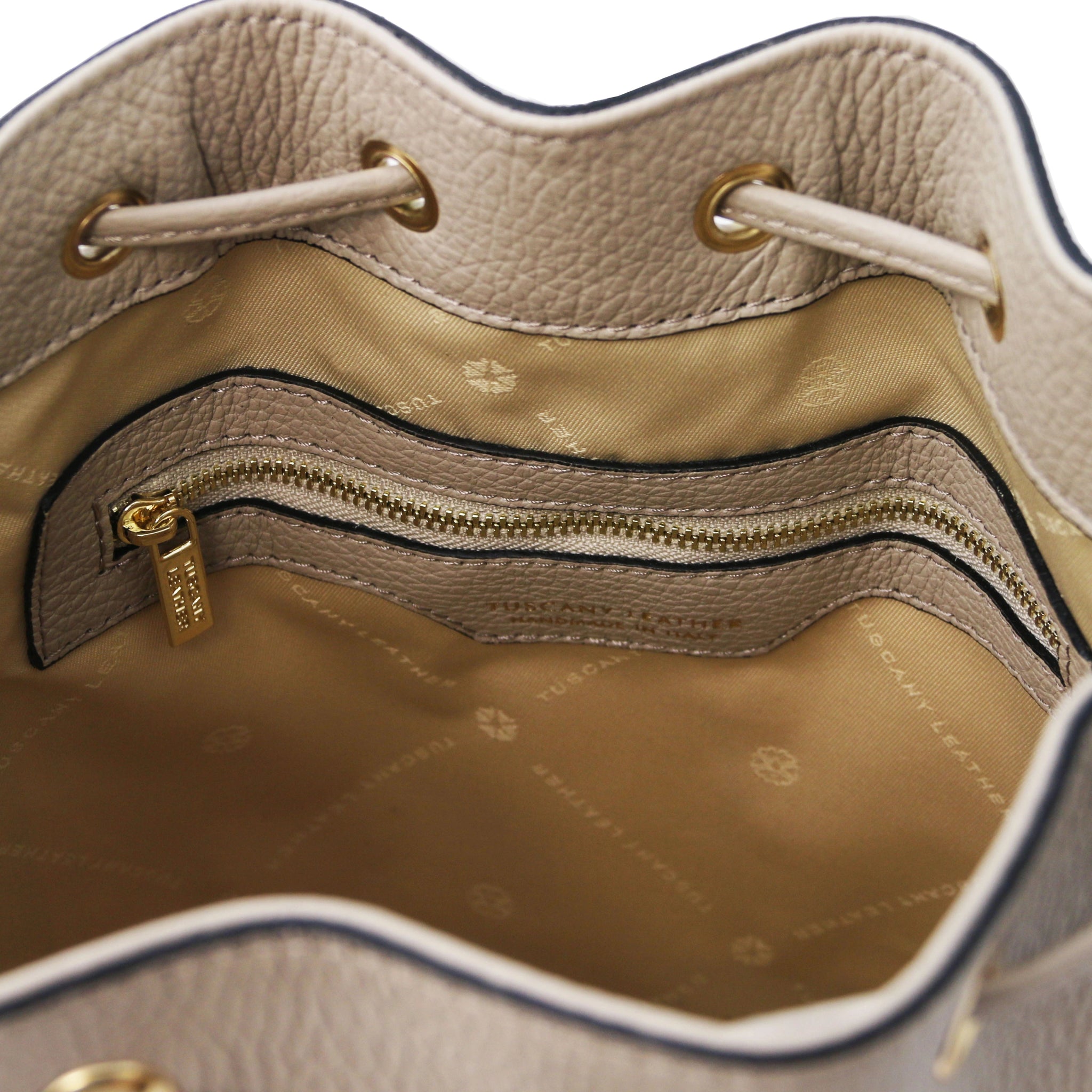 Interior zip pocket view of TL Italian Leather Bucket Bag in light taupe showing beige lining