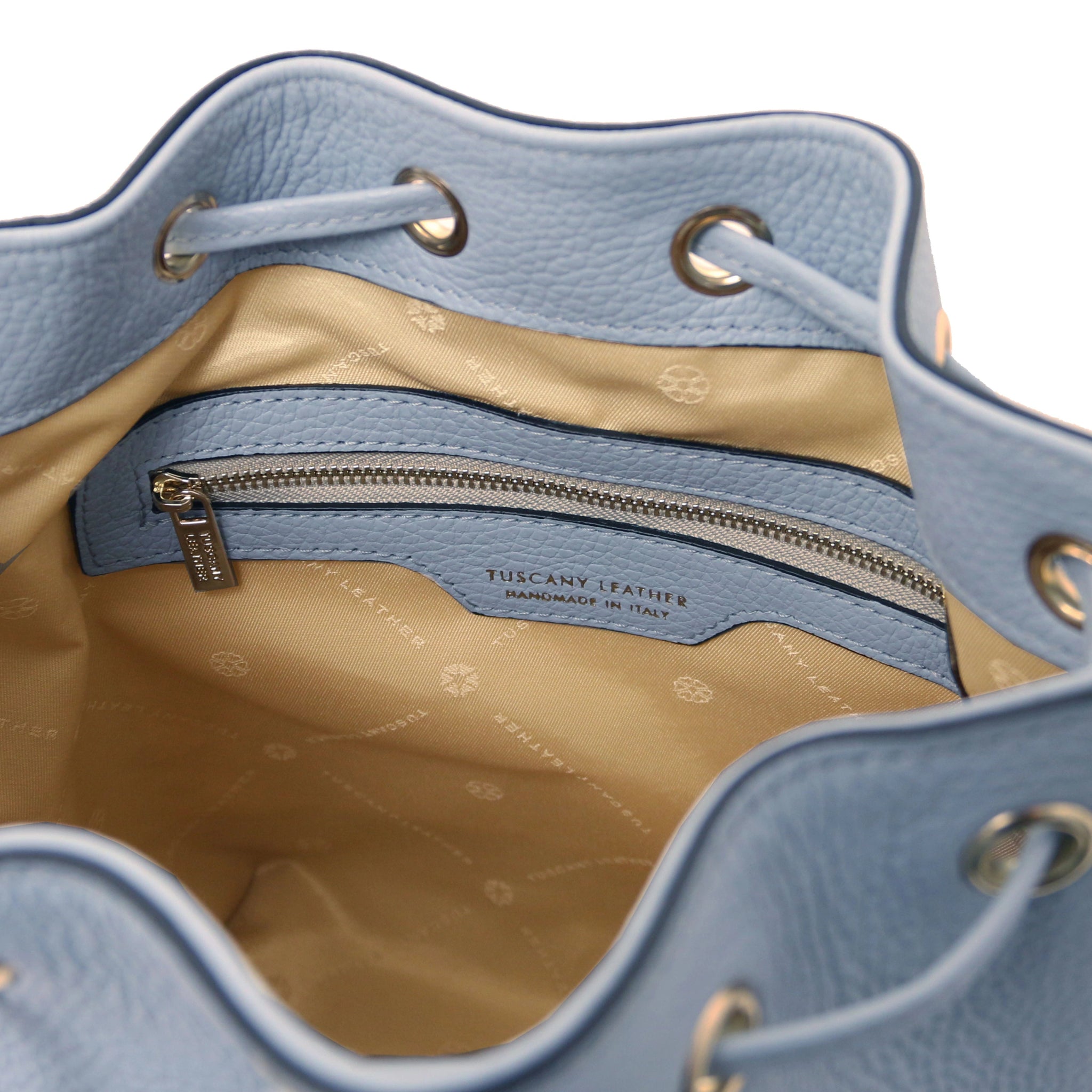 Interior zip pocket view of TL Italian Leather Bucket Bag in light blue showing beige lining