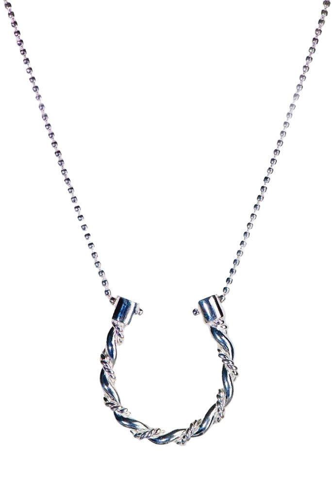 Triple Twist Lariat Horseshoe Necklace in Silveron a white lustrous background
