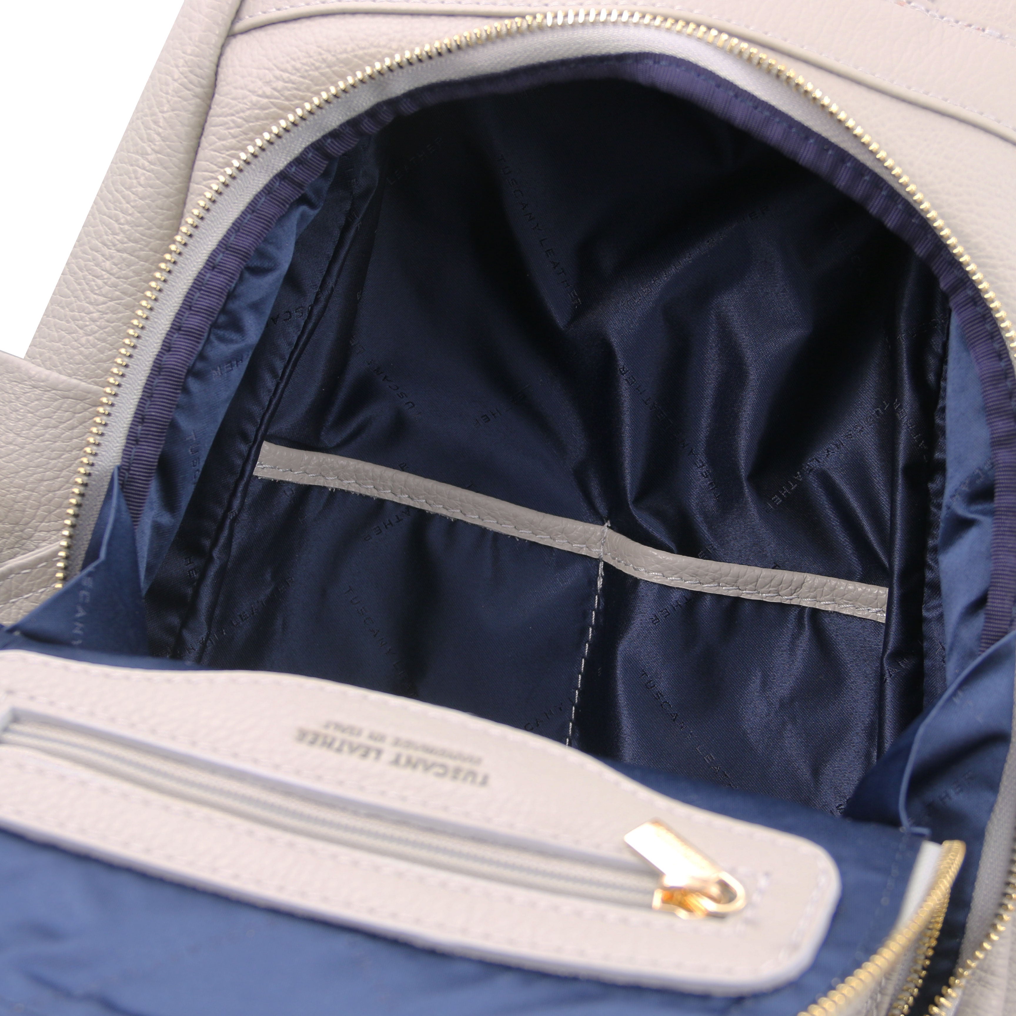 TL Bag Soft Leather Backpack in light gray showing Front exterior zip compartment two open and one zipper pockets, with blue lining