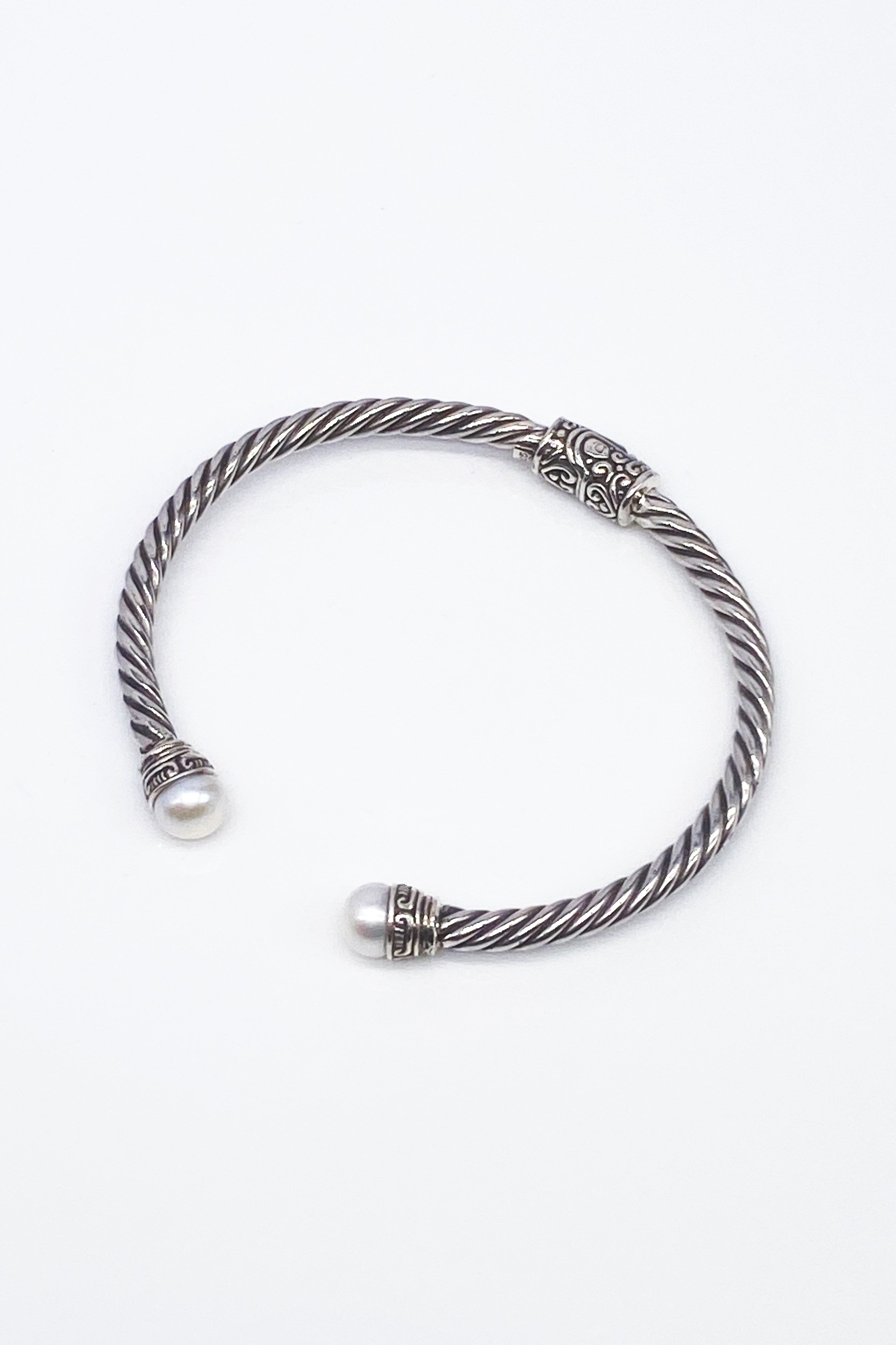 Balinese Pearl Hinged Bracelet with pearls on each end on a white background.