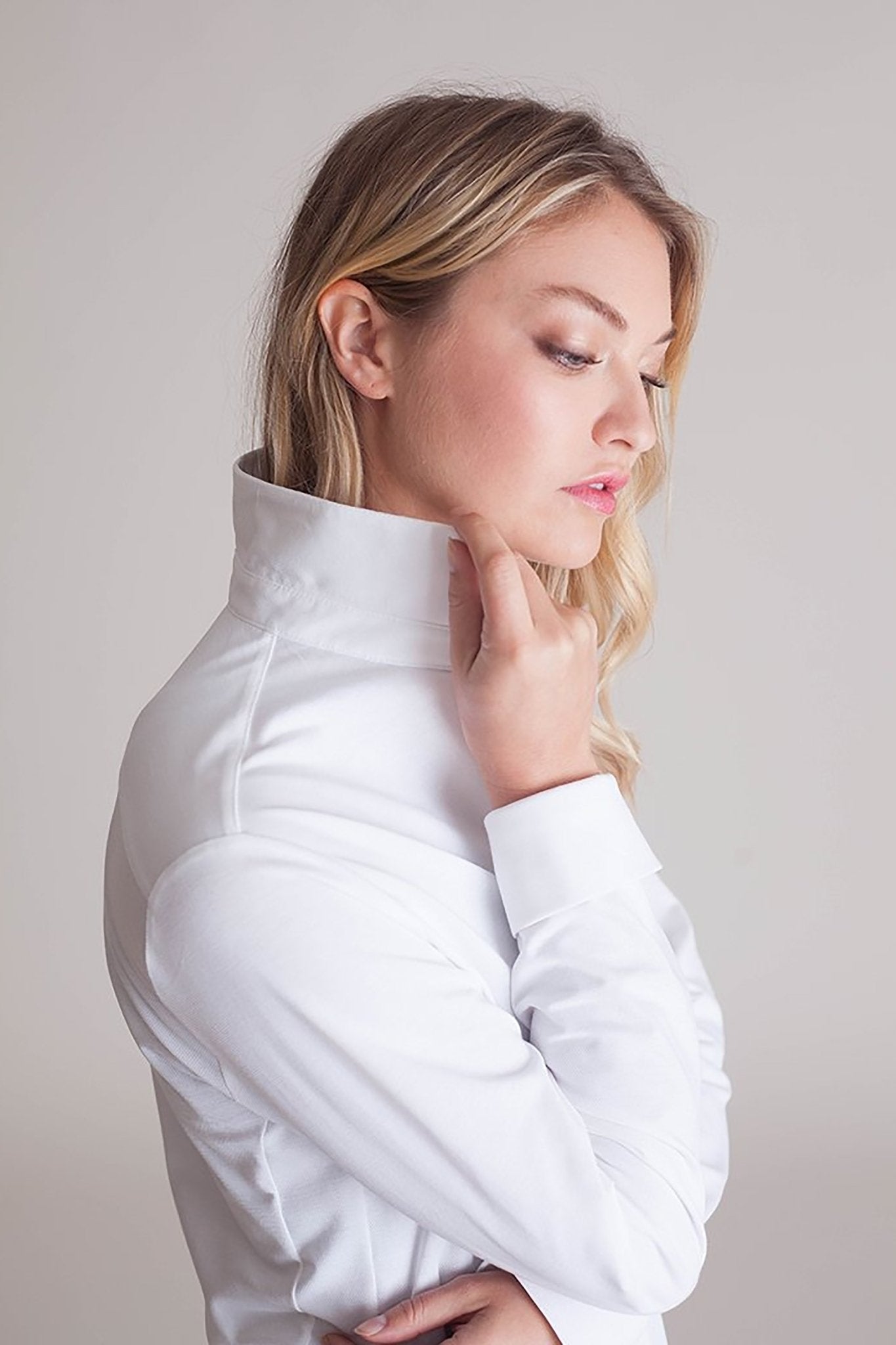 Side view of a female model wearing black pants and the All Day Comfort White Shirt - L'Atelier Global