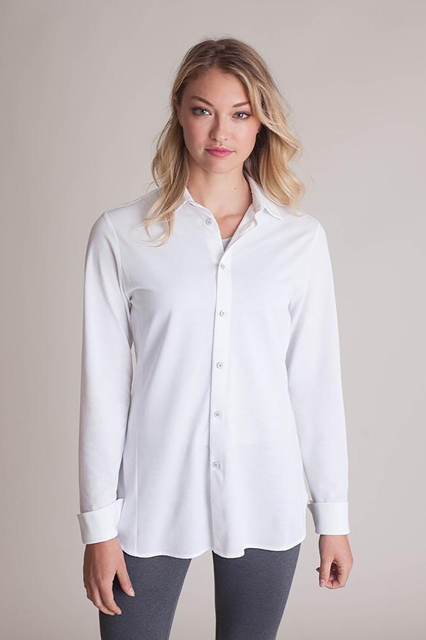 Front view of a female model wearing black pants and the All Day Comfort White Shirt - L'Atelier Global